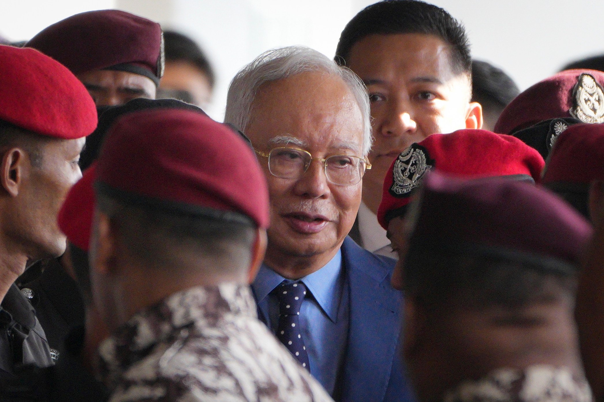 Malaysia’s former prime minister Najib Razak (centre) is escorted by prison officers on his arrival at the Kuala Lumpur High Court complex in October 2024. Photo: AP