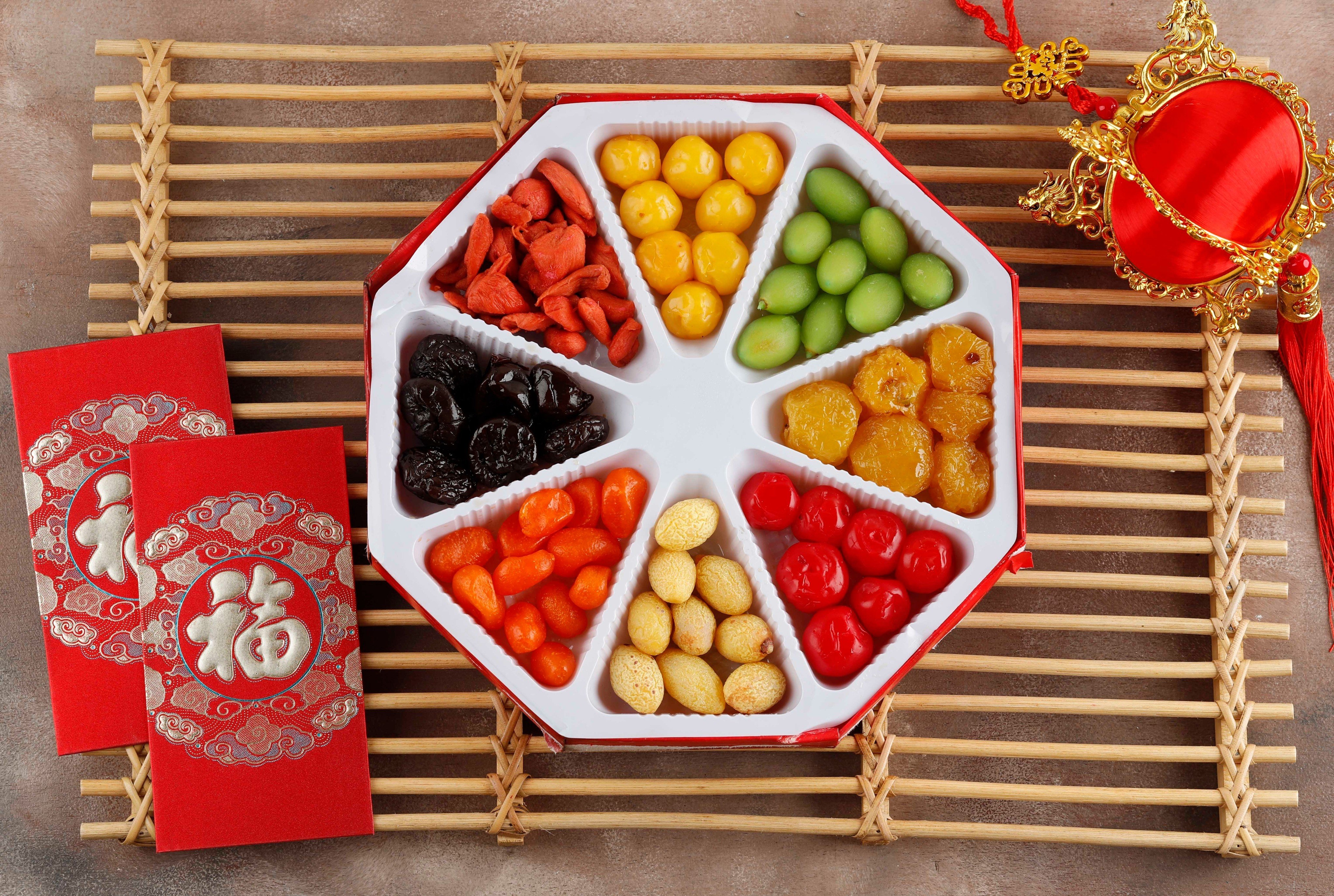 A traditional chuen hup usually has eight compartments, and the snacks within are collectively called the “Eight Sweets”. 
The typical line-up – all candied – consists of lotus root, lotus seeds, water chestnuts, winter melon, carrot slices, kumquat, coconut shreds and coconut wedges. Photo: Shutterstock