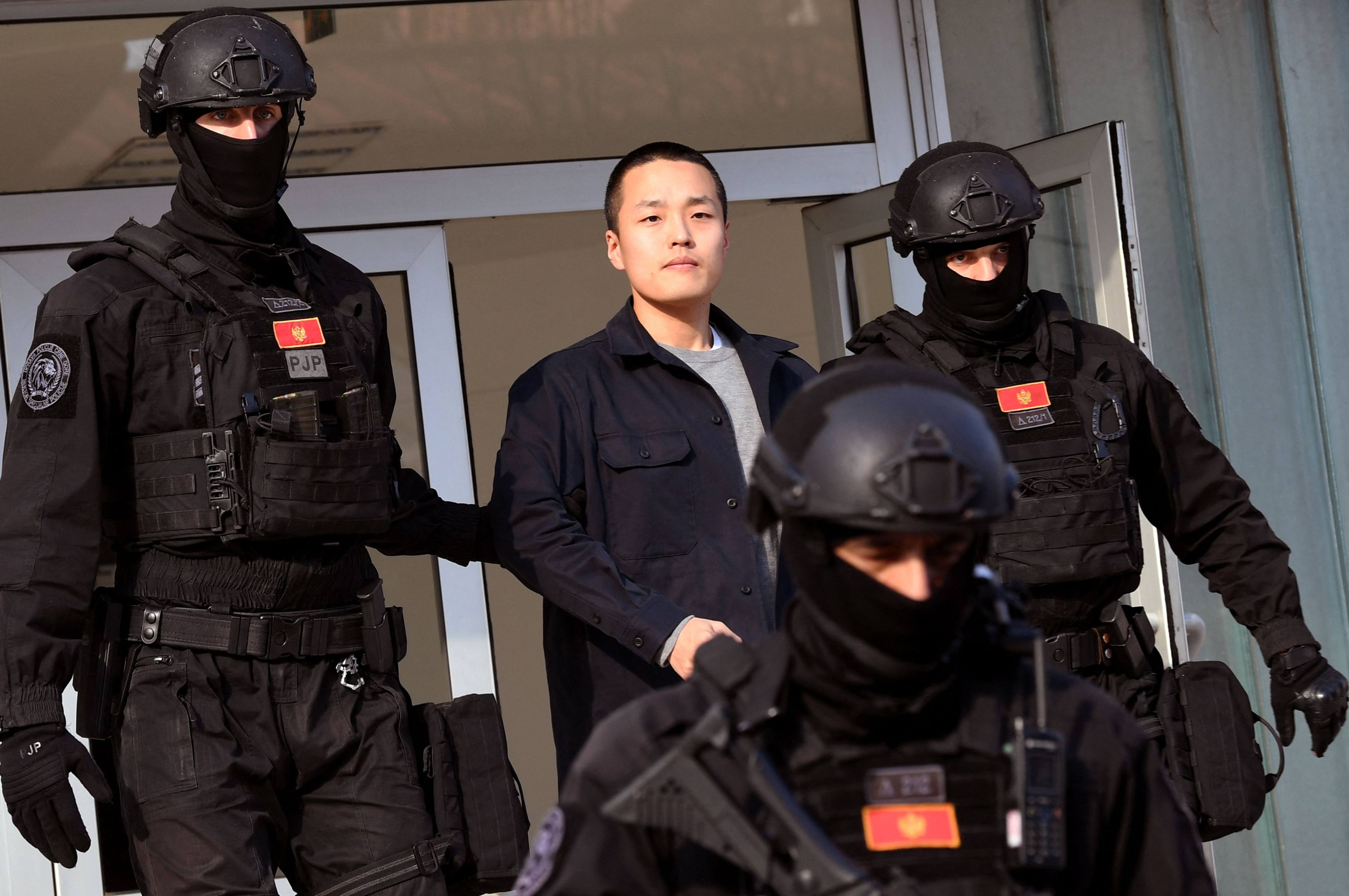 Montenegrin police escort South Korean cryptocurrency entrepreneur Do Kwon, centre. Photo: AFP