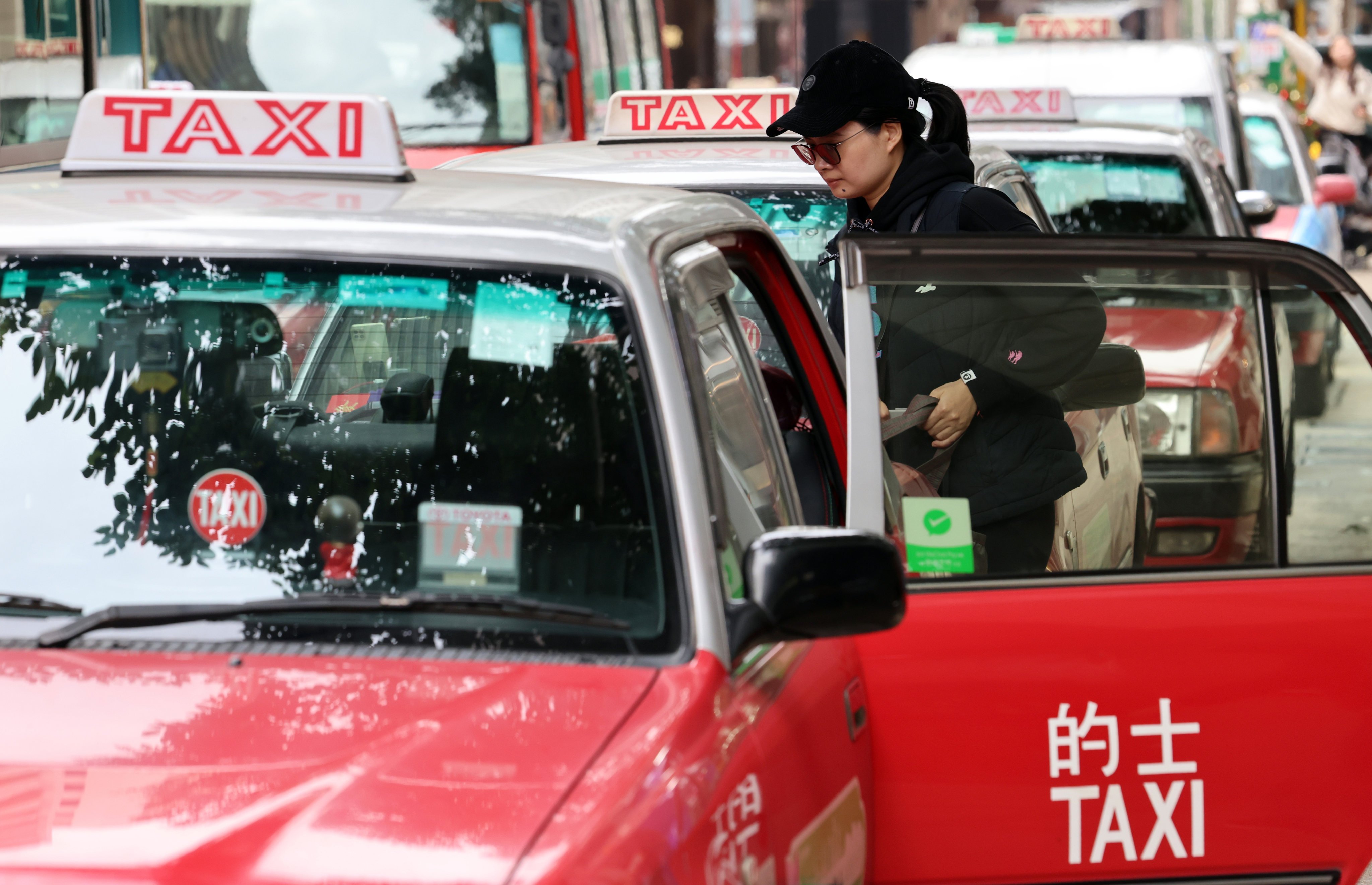 A passenger gets into a cab at a taxi stand along Canton Road in Tsim Sha Tsui. The government issued five taxi fleet licences five months ago in an effort to improve the industry’s service quality. Photo: Jelly Tse