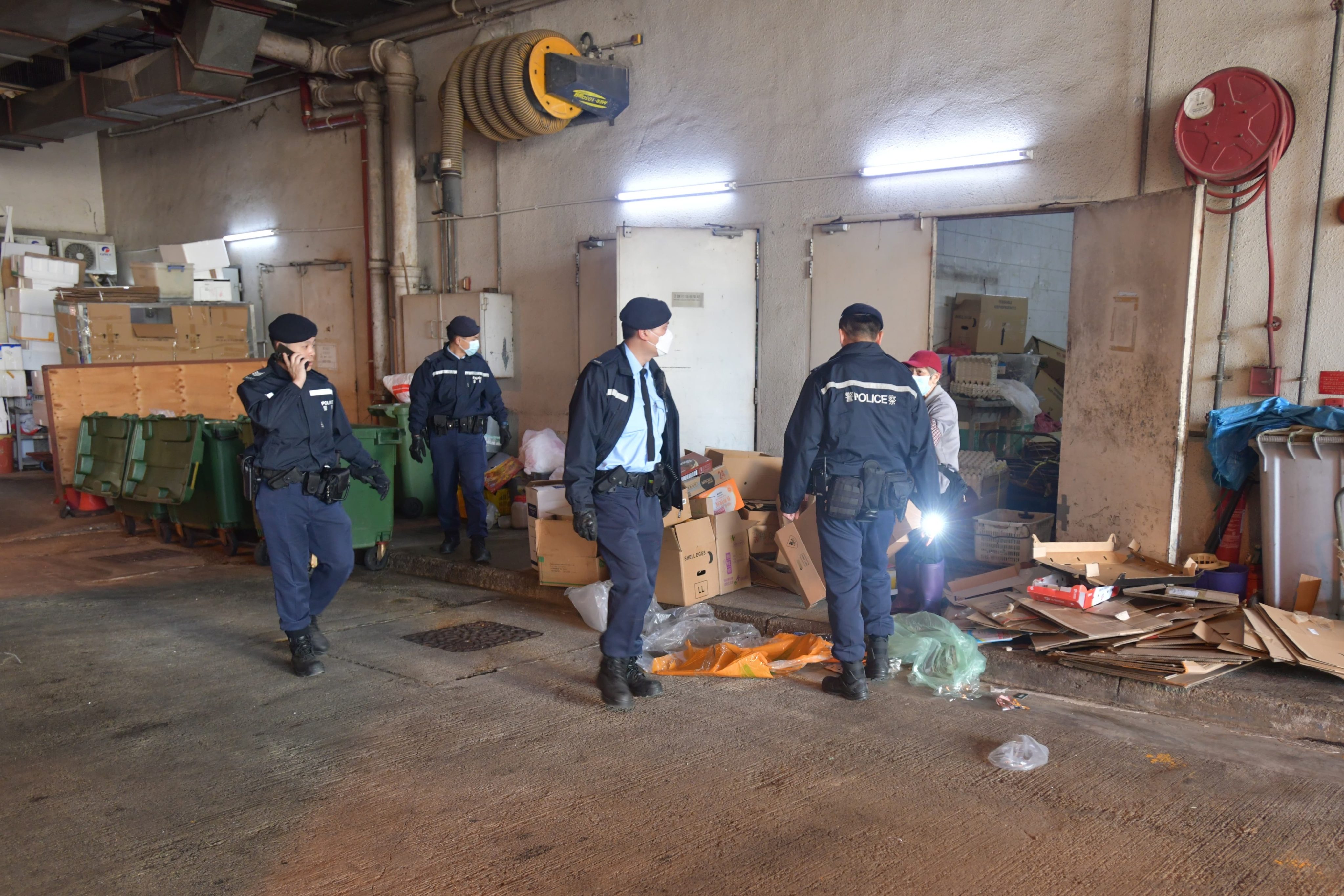 Police officers search a refuse collection point in Po Tin Estate. Photo: Handout