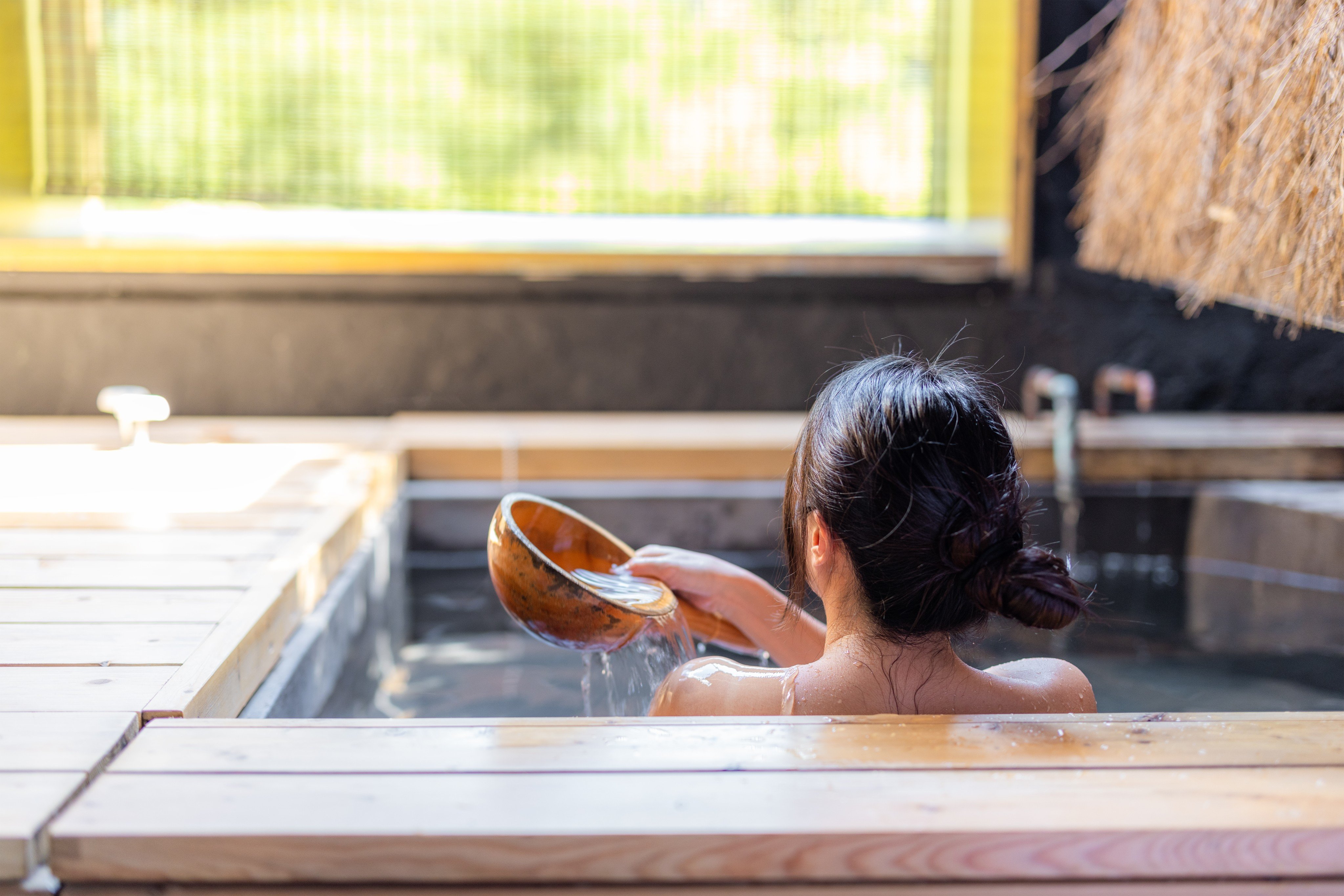 A woman enjoys a hot bath at an onsen resort in Japan. Photo: Shutterstock