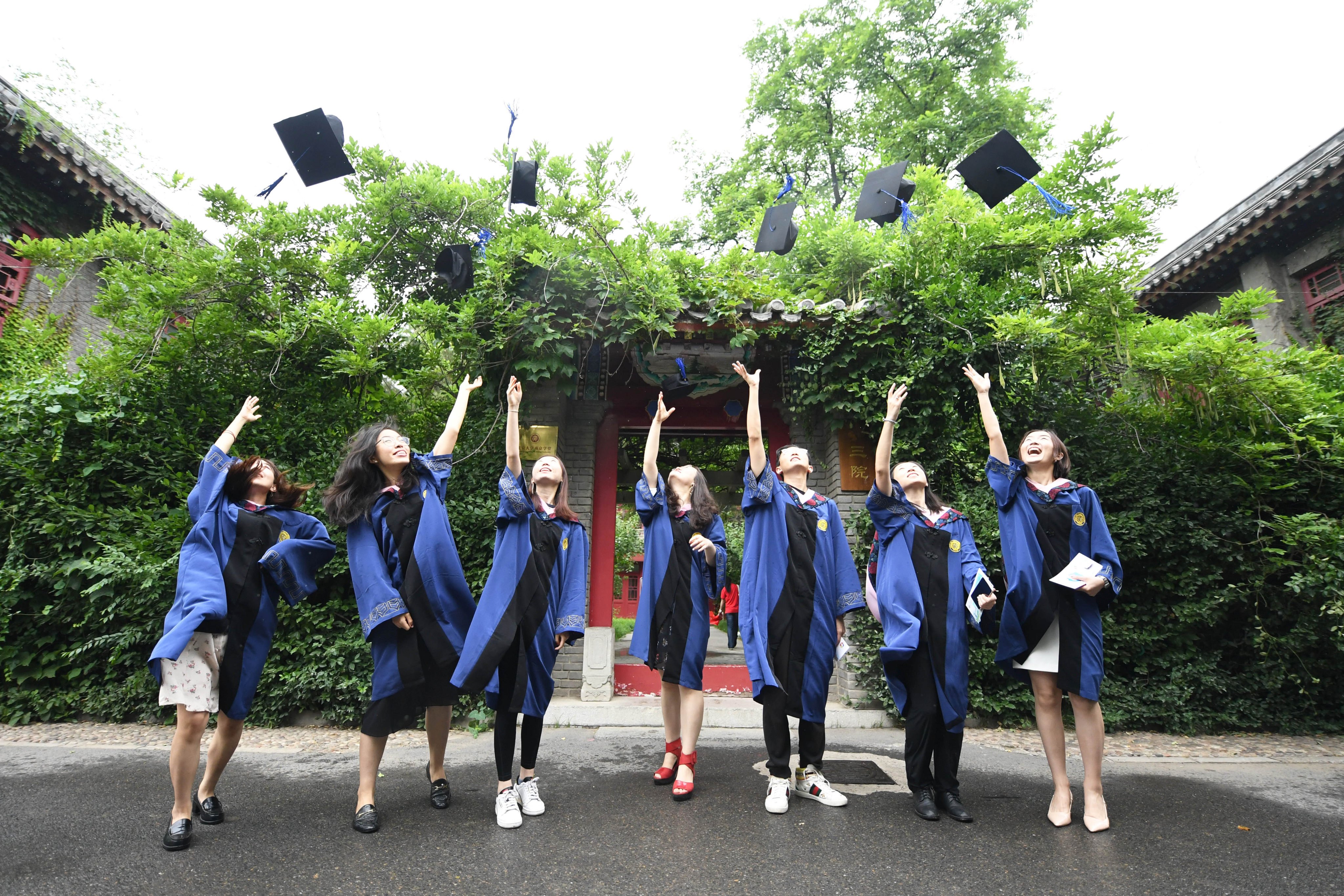 Students celebrate graduating from Peking University. Chinese employers have been accused of “worshipping” graduates from the elite institution in Beijing. Photo: Xinhua