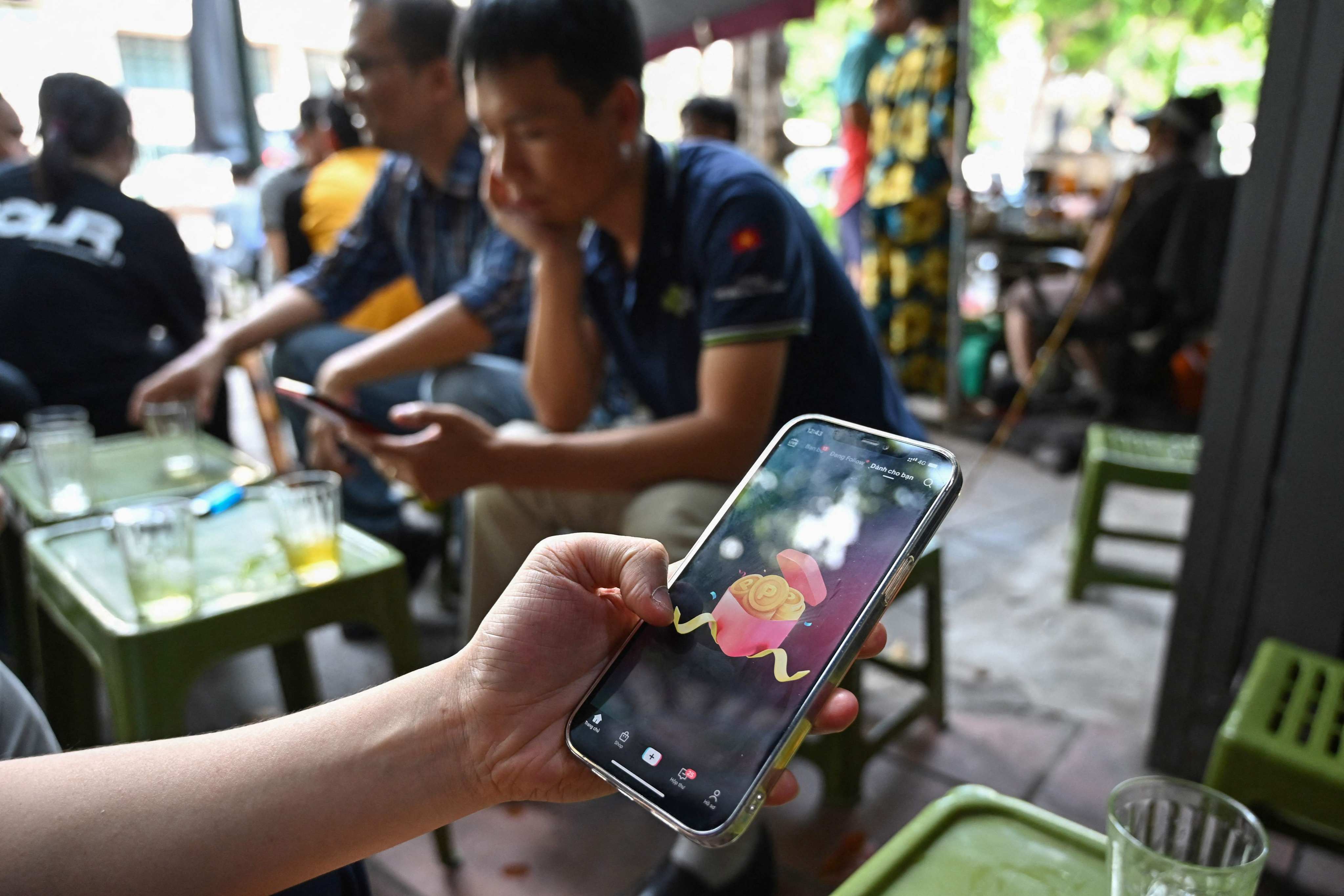 A man in Hanoi looks at TikTok content on his smartphone in October 2023. Photo: AFP