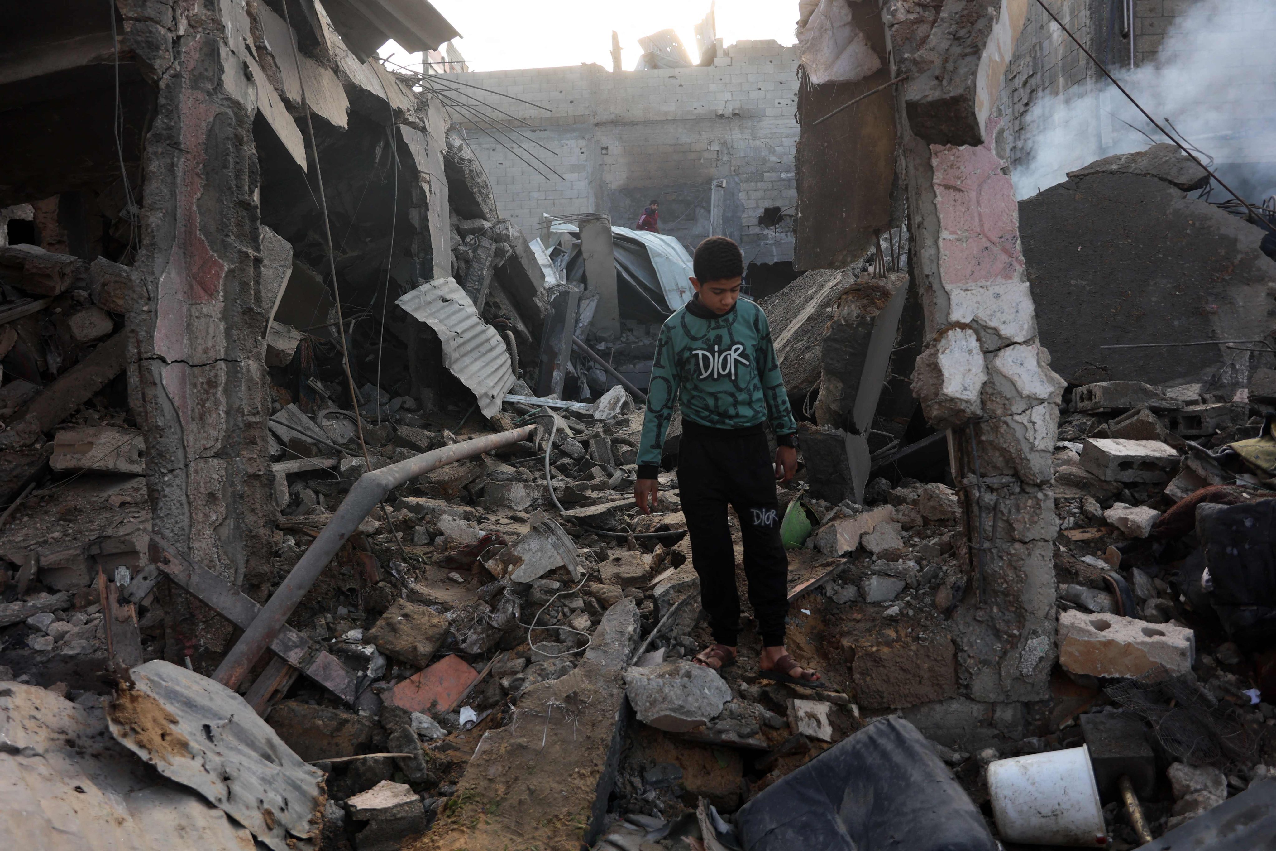 A Palestinian boy walks amid the destruction following an Israeli strike on a home in the Shujaiya neighbourhood of Gaza City, on Saturday. Photo: AFP