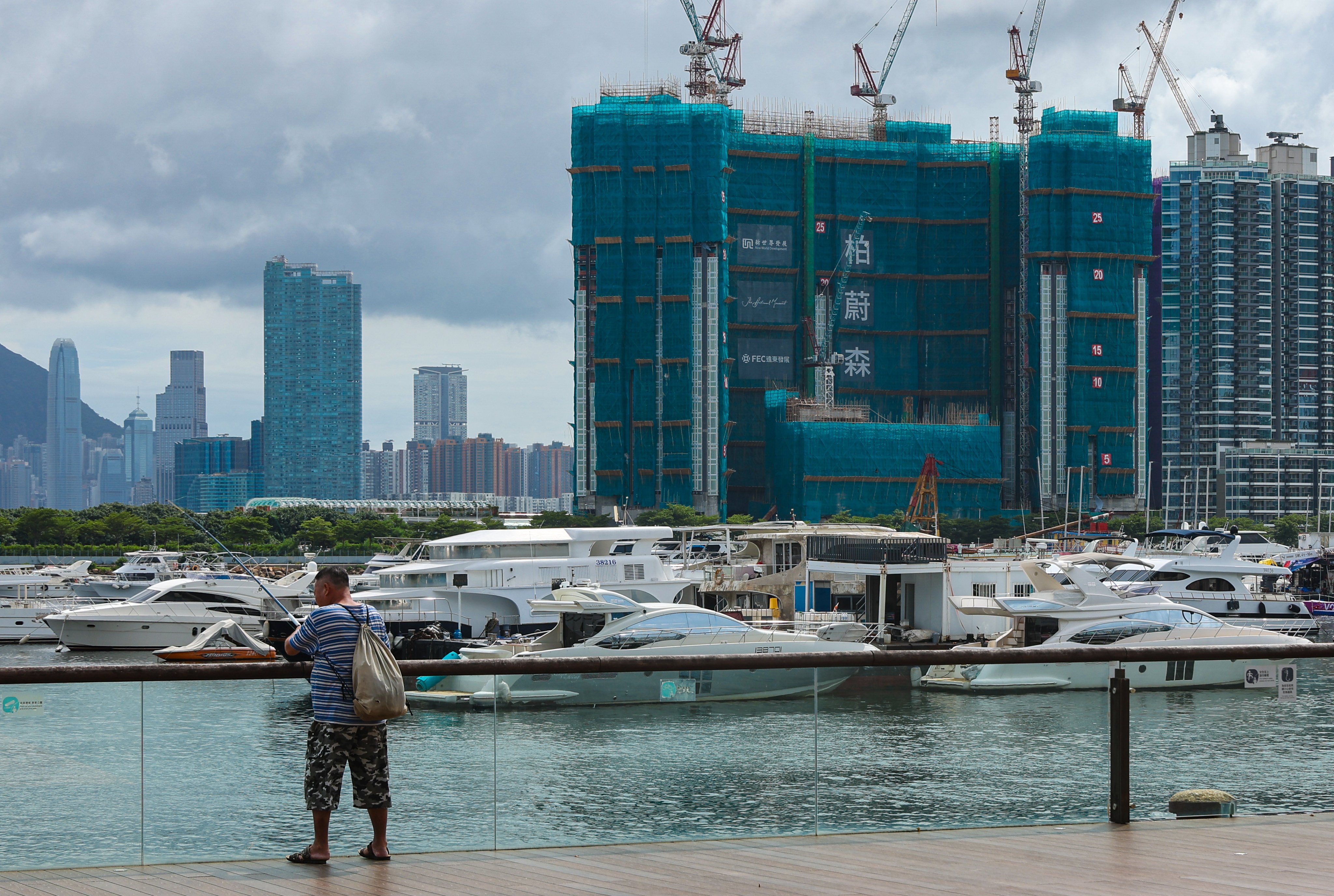 A man fishes in view of Pavilia Forest, developed by New World Development in Hong Kong’s Kai Tak area, on July 21, 2024. Photo: Edmond So