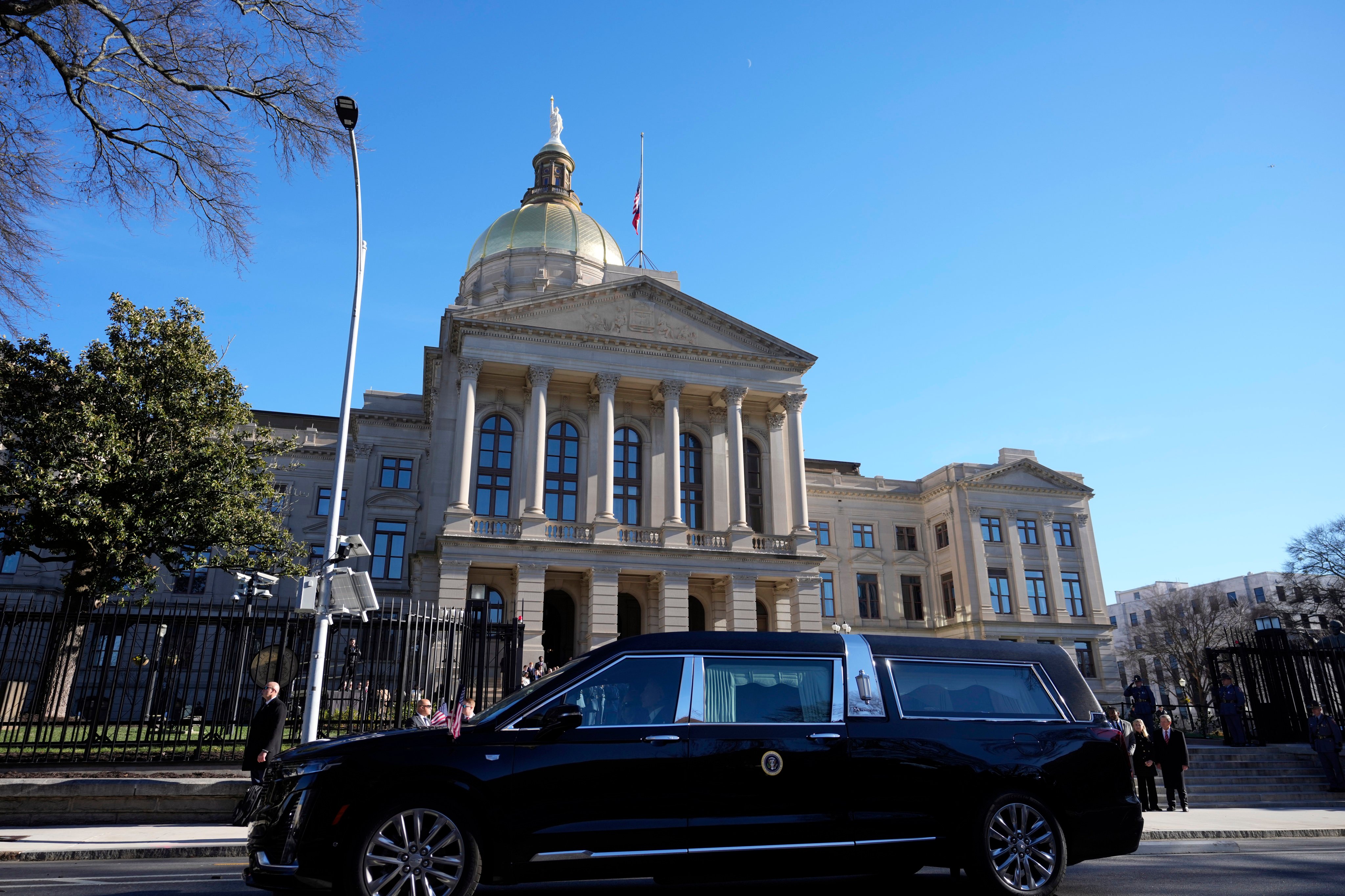 The hearse carrying the flag-draped casket of former US president Jimmy Carter pauses outside the State Capitol in Atlanta on Saturday. Photo: AP