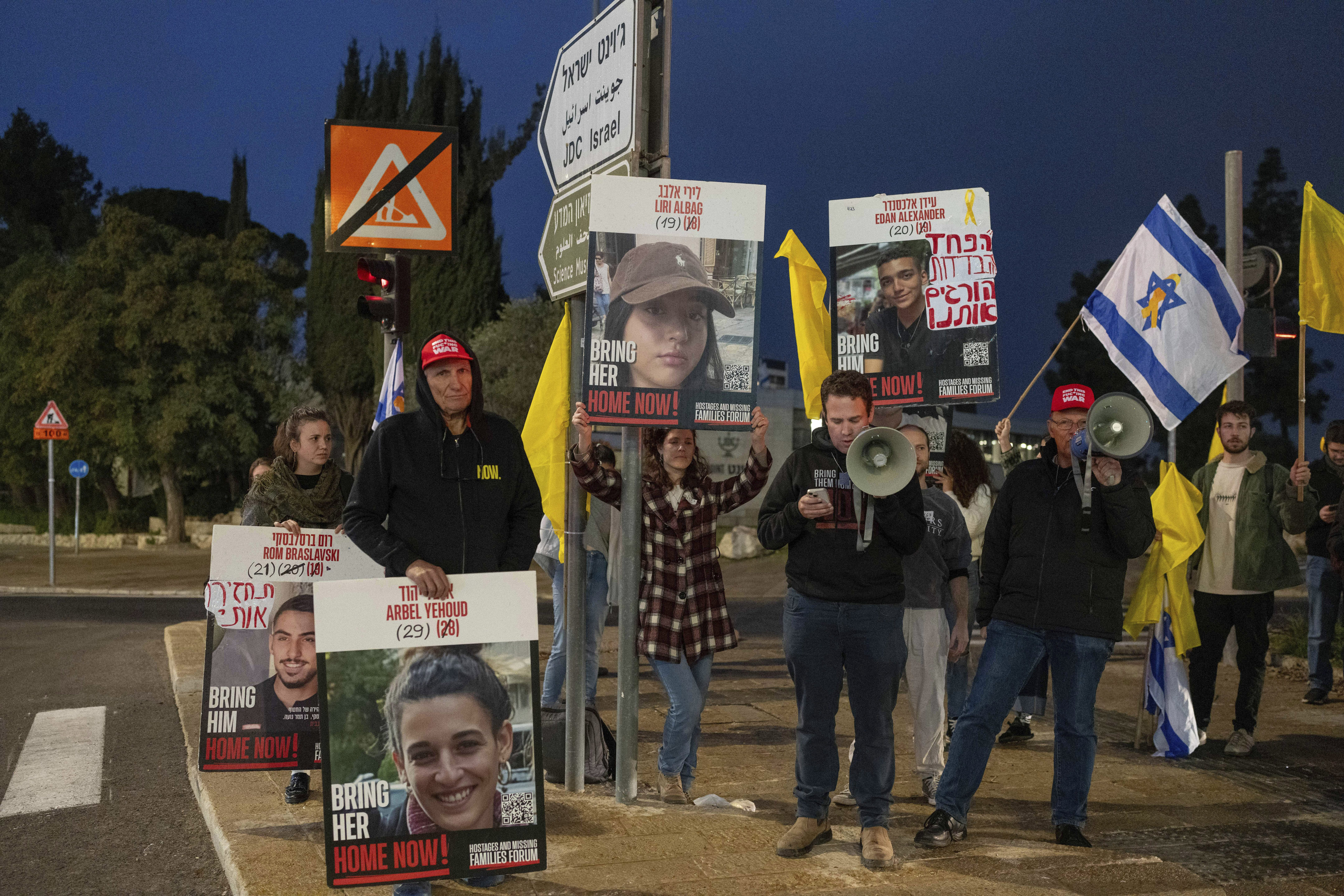 Israeli protesters outside the prime minister’s office in Jerusalem on Sunday hold photos of Liri Albag and other hostages, during a demonstration calling for their release from Gaza. Photo: AP