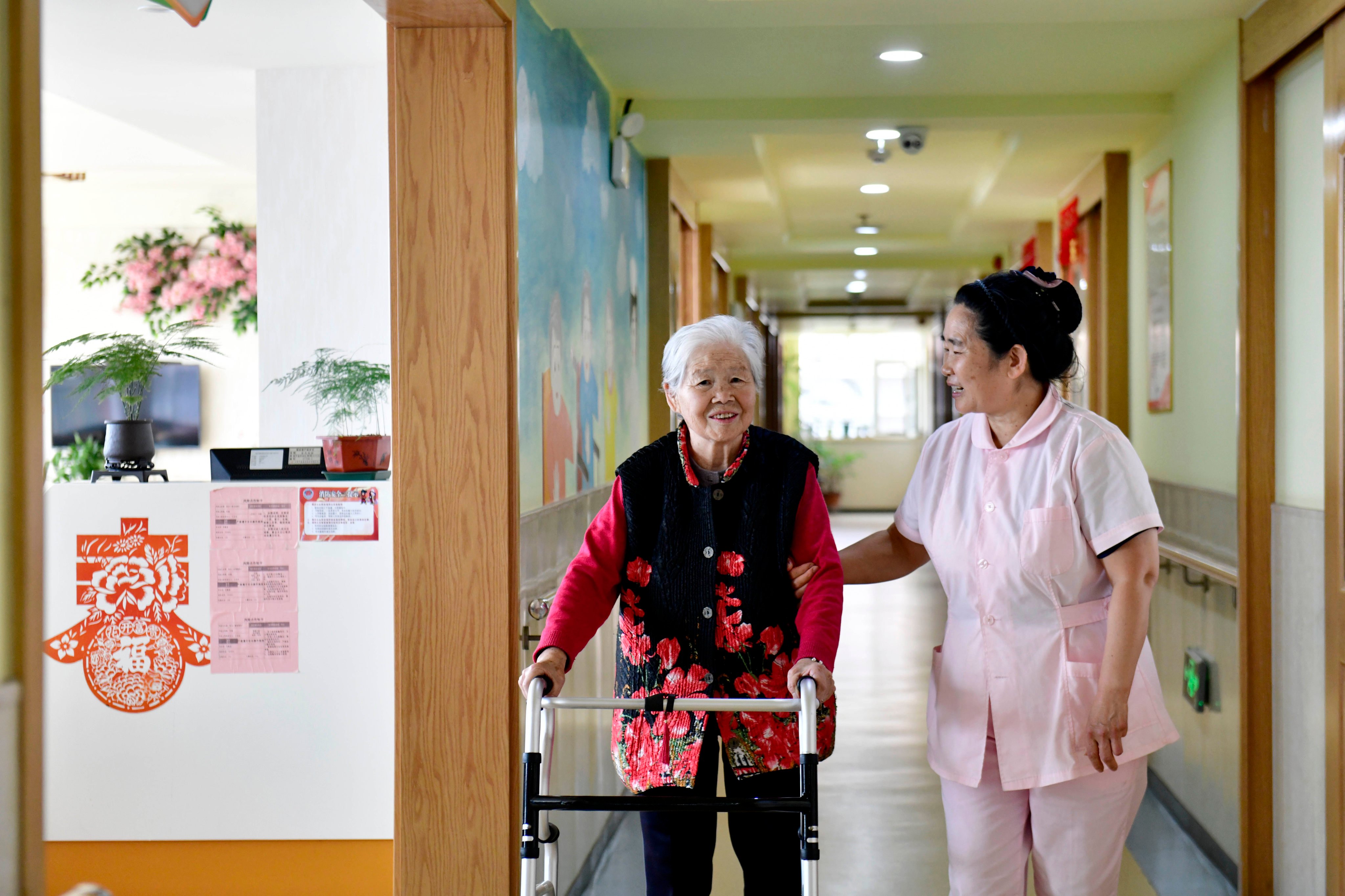 A member of staff helps an elderly resident at a nursing home in east China’s Shandong province. Photo: Xinhua