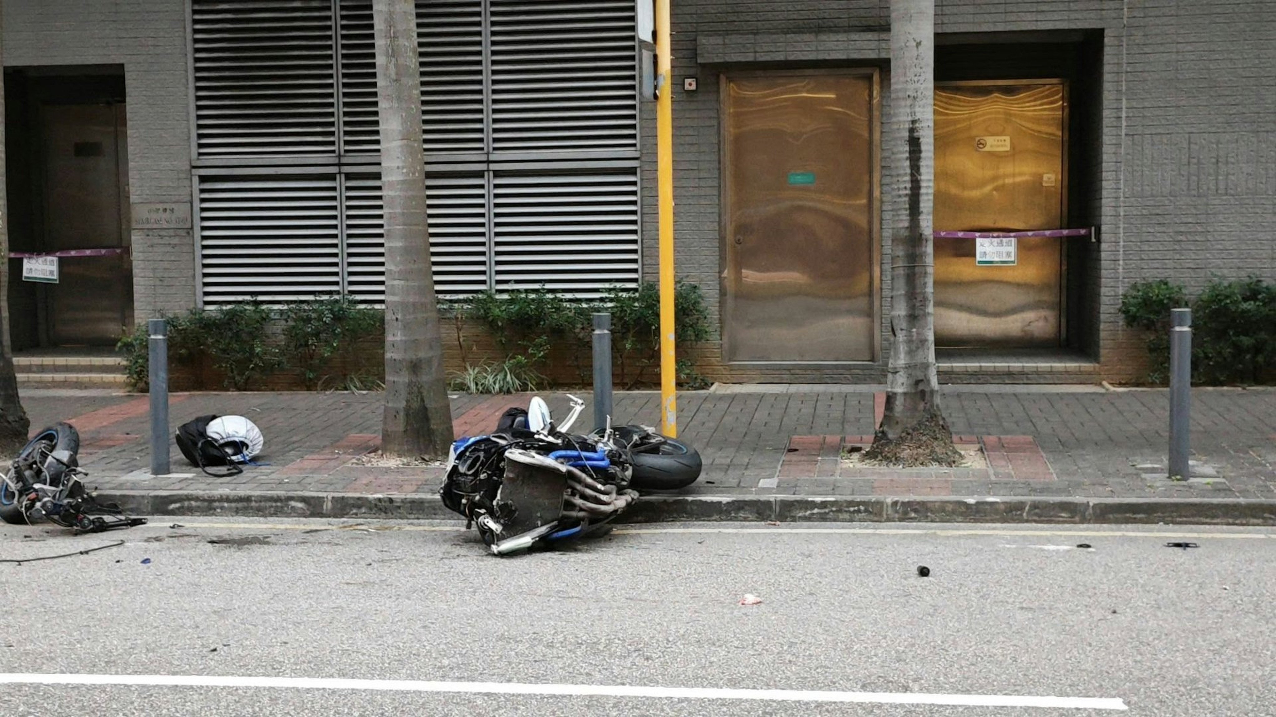 The motorcycle veered out of control and collided with a roadside metal pole. Photo: Facebook/Dennis Lui