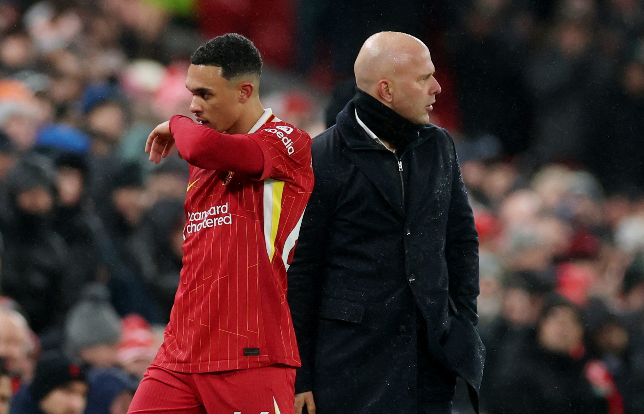 Liverpool defender Trent Alexander-Arnold walks off the pitch past manager Arne Slot after the draw with Manchester United. Photo: Reuters