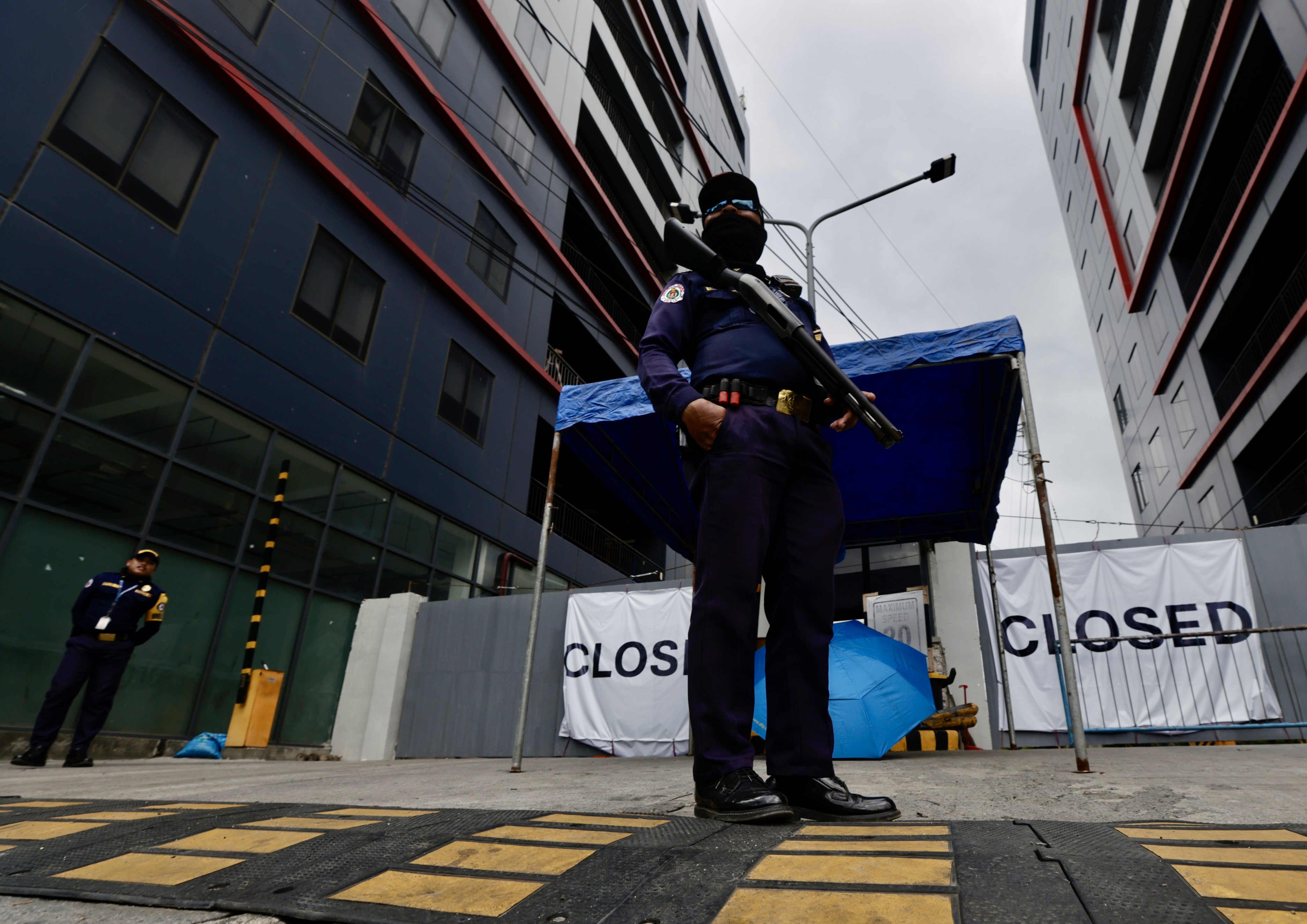 Security officers stand guard at the gates of a closed online gambling building, the largest Philippine Offshore Gaming Operators (Pogo) hub in the country, in the town of Kawit, Cavite province, the Philippines, on December 29, 2024. Photo: EPA-EFE