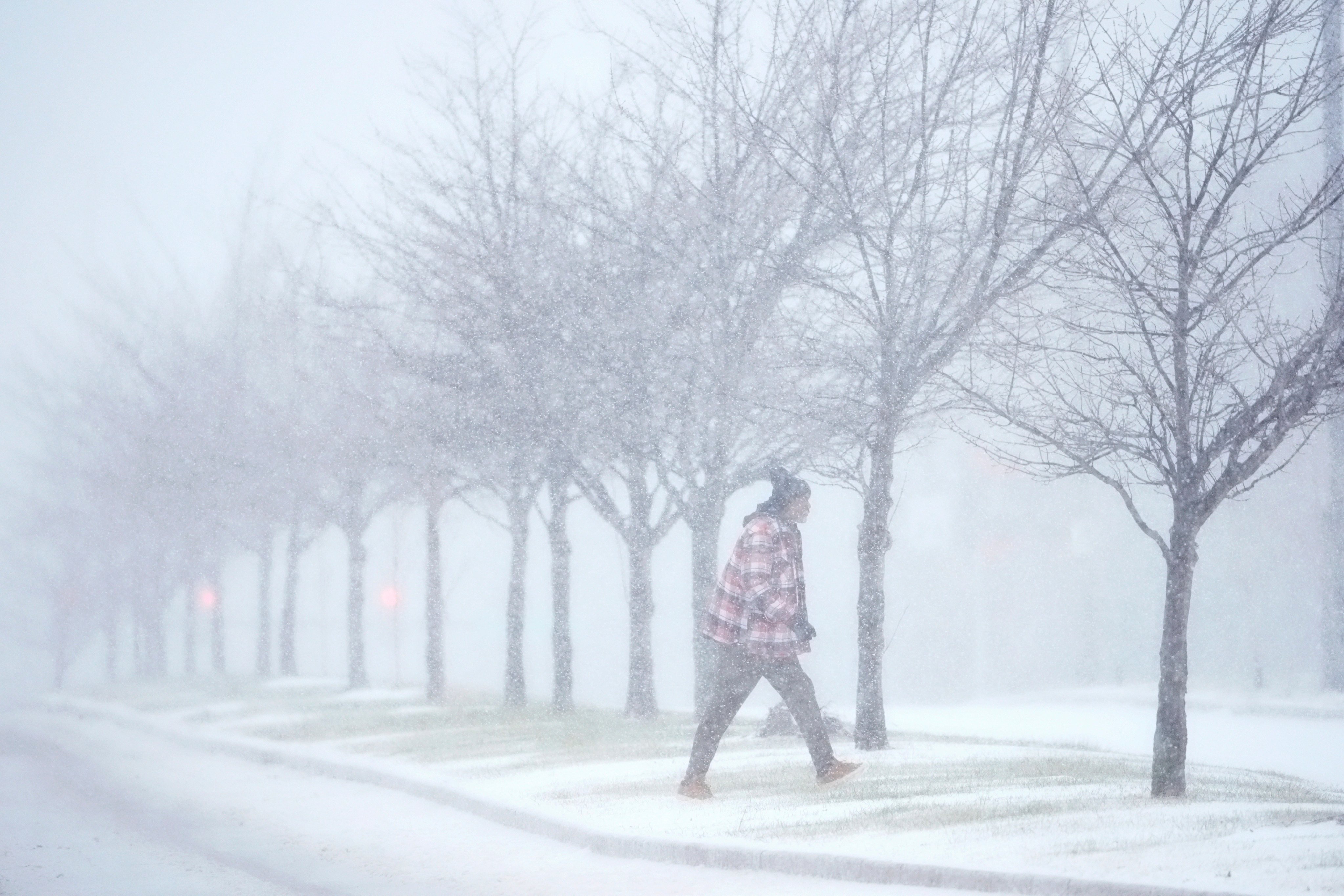 A person crosses a street as heavy snow falls in St Louis. Photo: AP