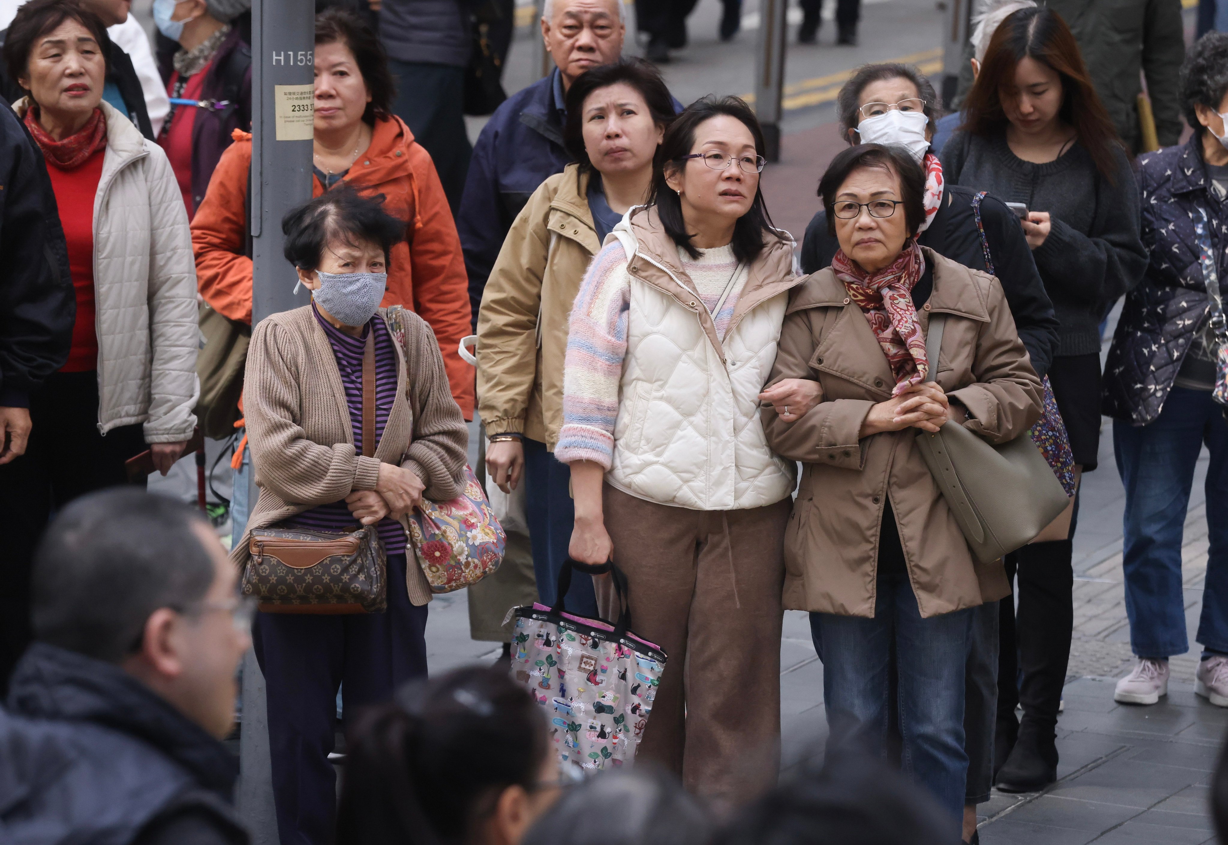 Residents in Causeway Bay dress warmly for the cold weather in mid-December. Photo: Jonathan Wong