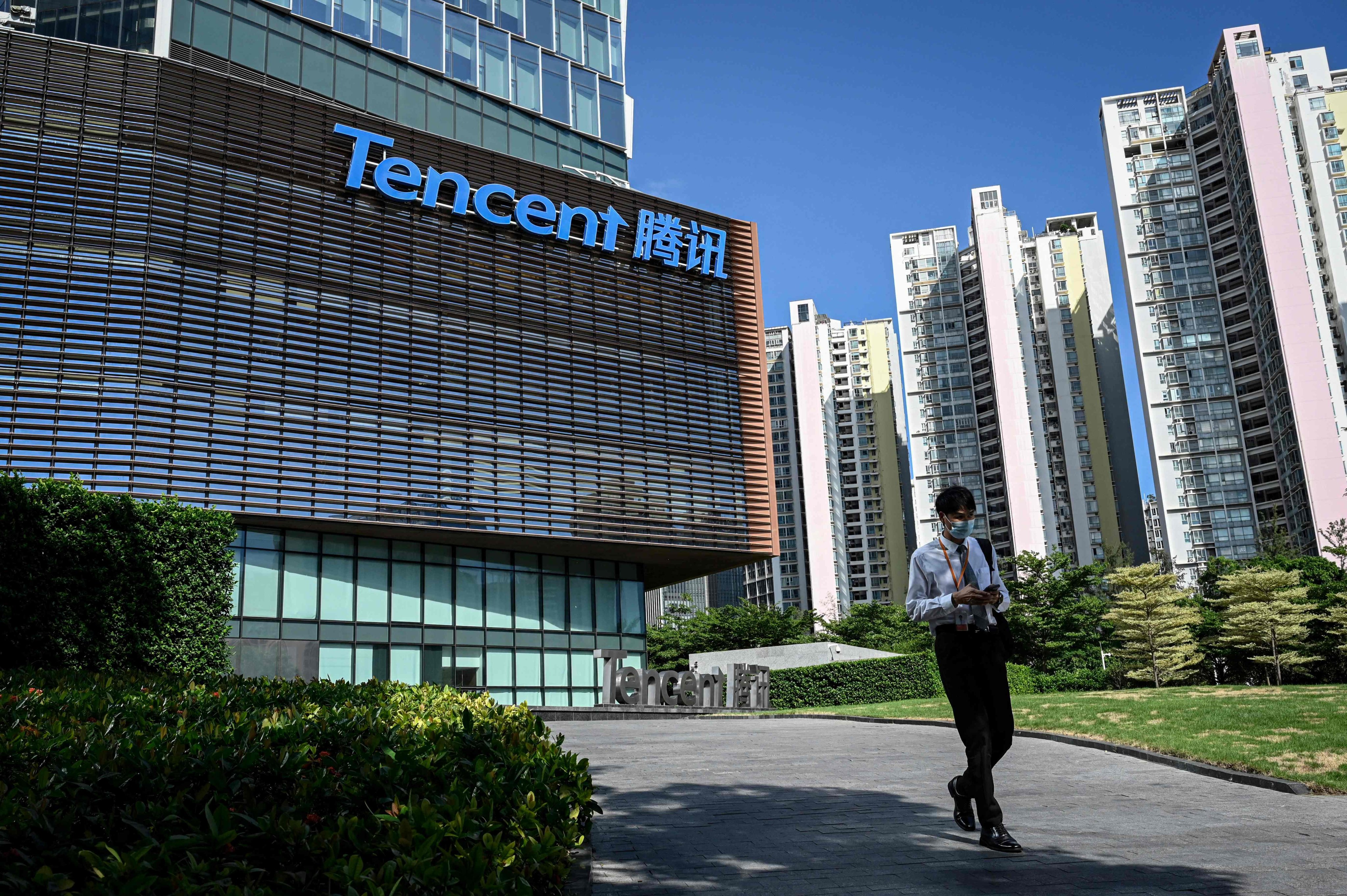 A man walks past the Tencent headquarters in Shenzhen, China. Photo: AFP