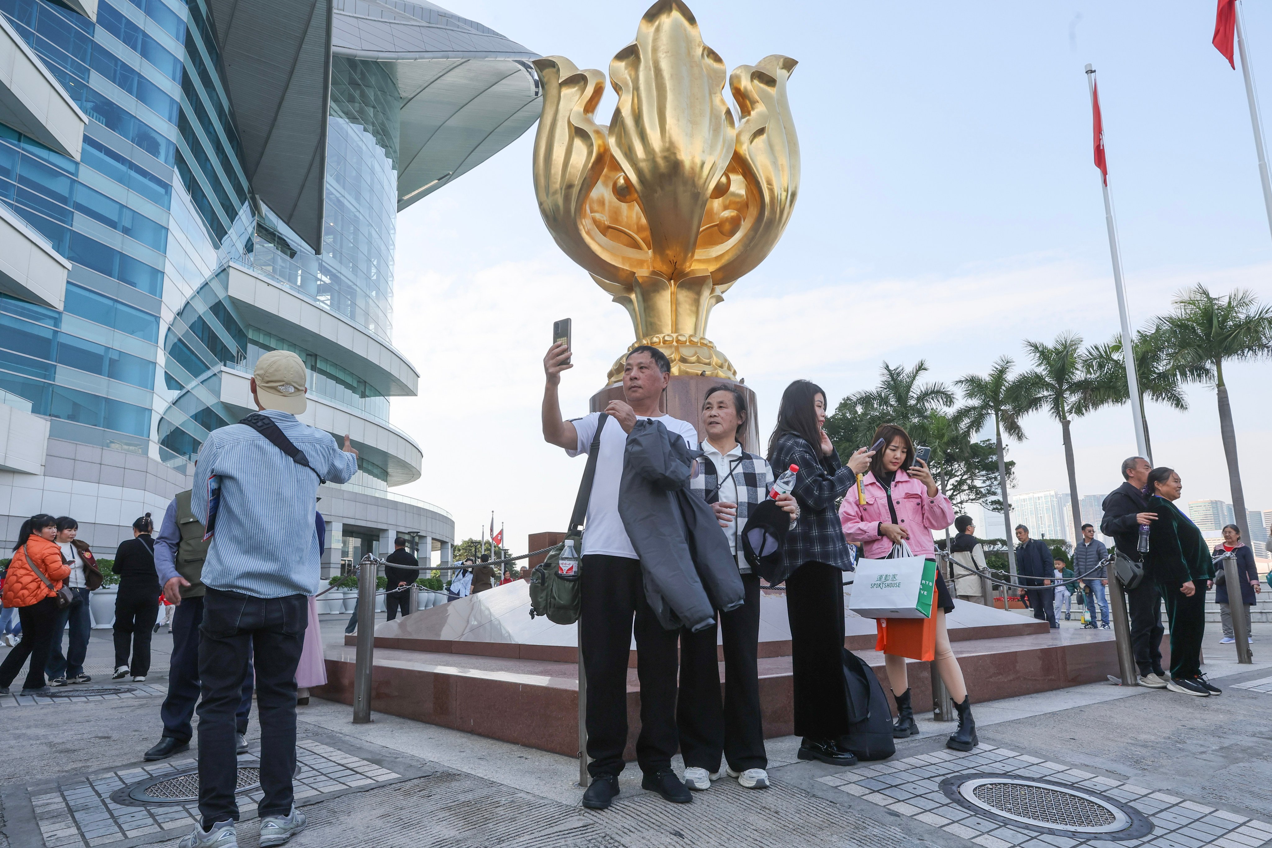 Tourists visit Golden Bauhinia Square in Wan Chai. Hong Kong. Photo:  Edmond So