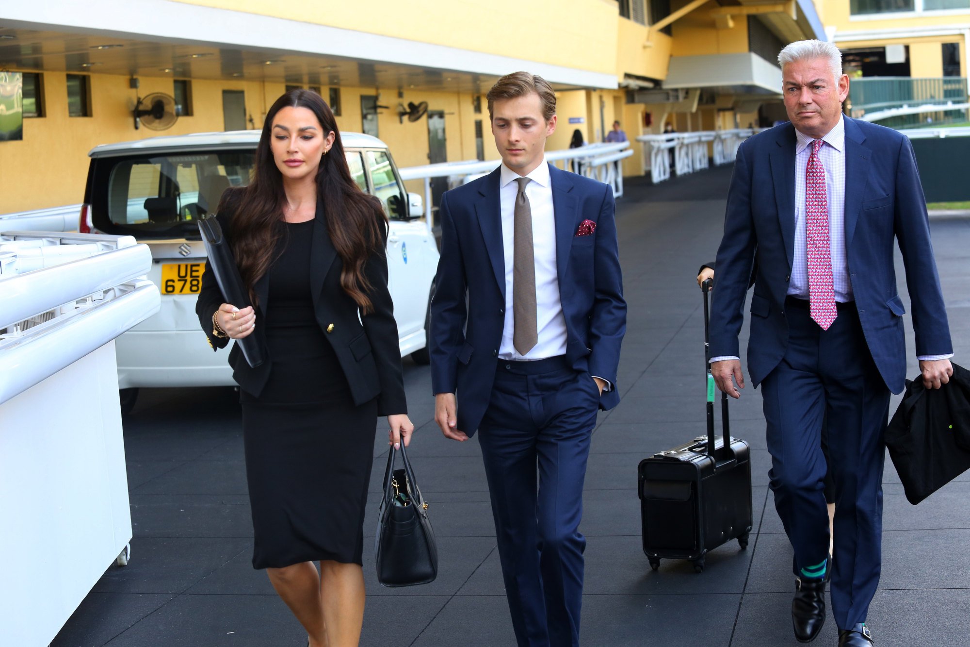 Jockey Harry Bentley (centre) and his legal team attend an inquiry at Happy Valley.