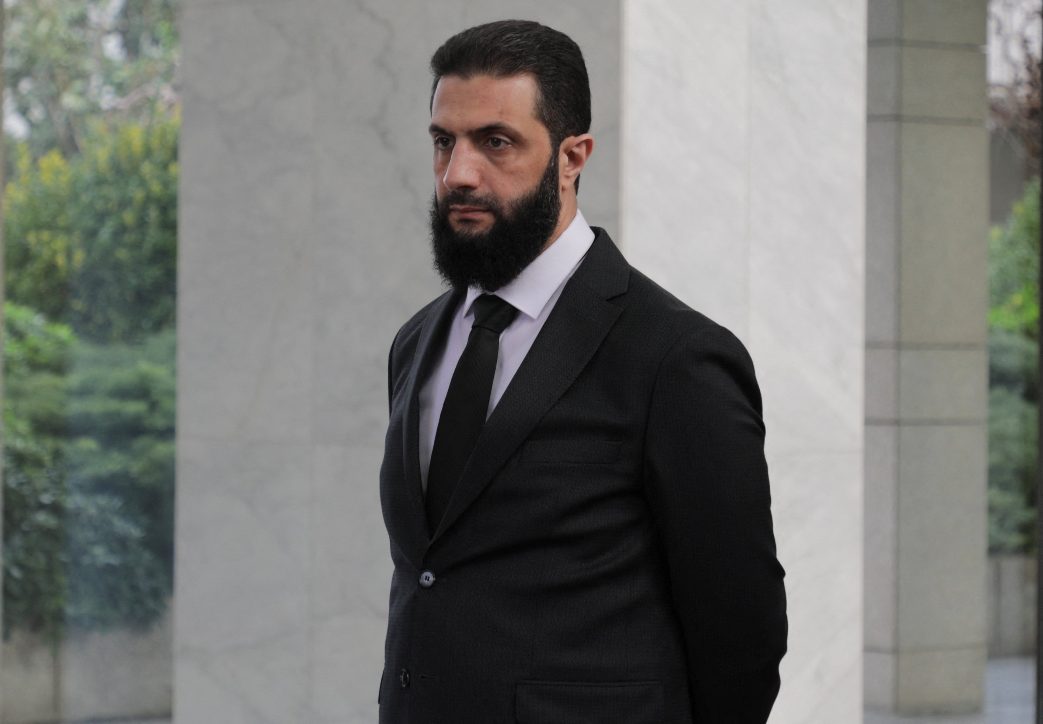 Syrian leader Abu Mohammed al-Golani waits to welcome a Ukrainian delegation in Damascus, Syria, on December 30. The world has been beating a path to his door. Photo: Reuters