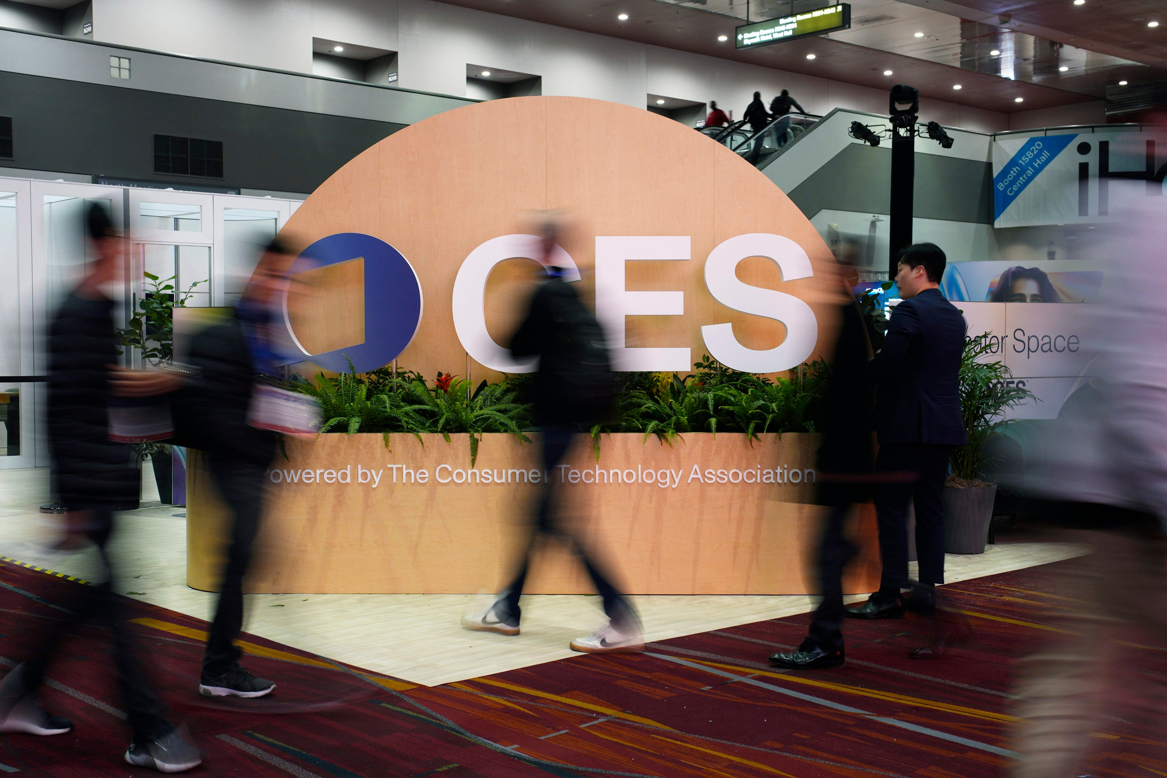 People walk by a sign ahead of the CES 2025 tech show in Las Vegas.  Photo: AP