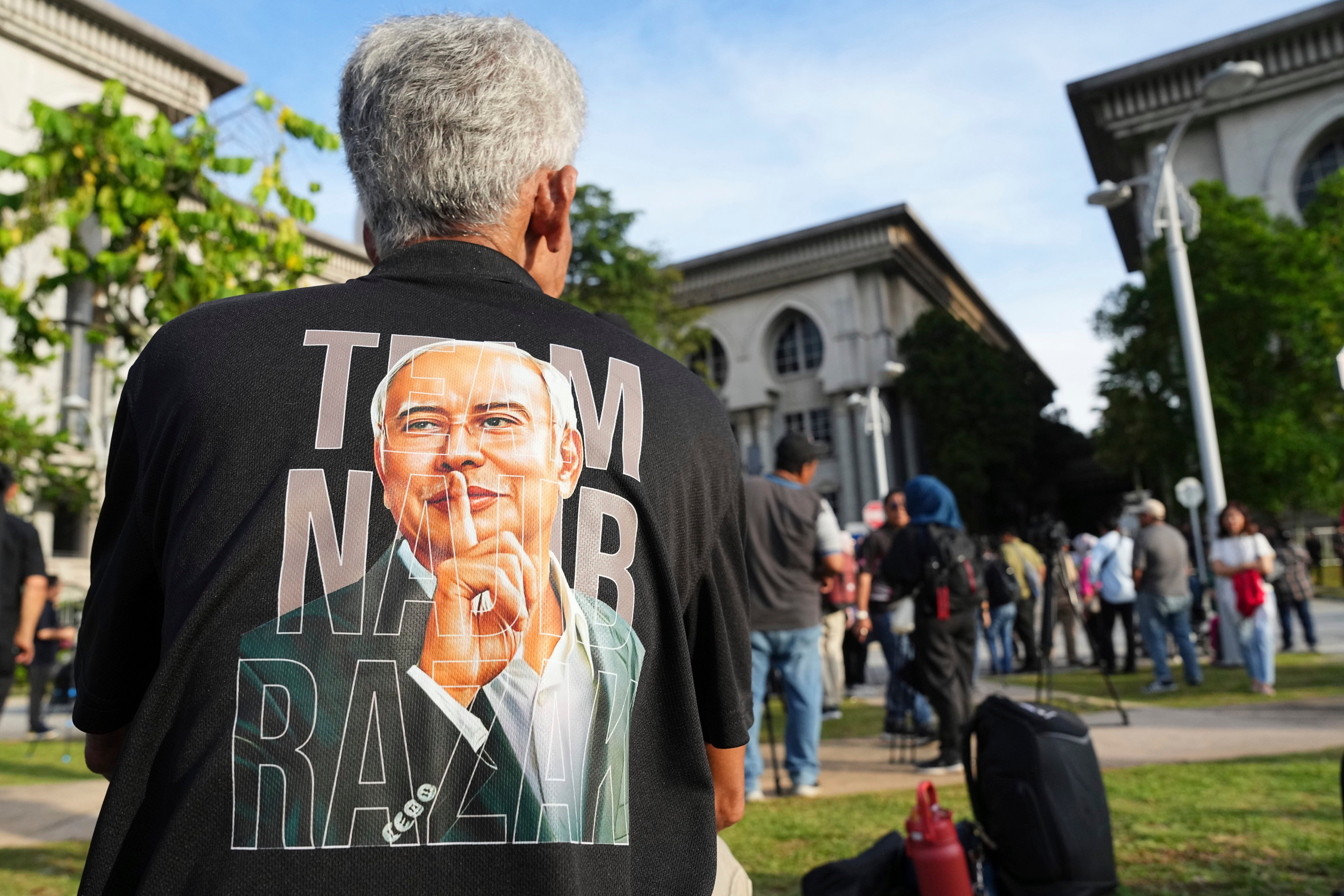 A supporter of former prime minister Najib Razak waits outside the Court of Appeal in Putrajaya, Malaysia, on Monday. Photo: AP