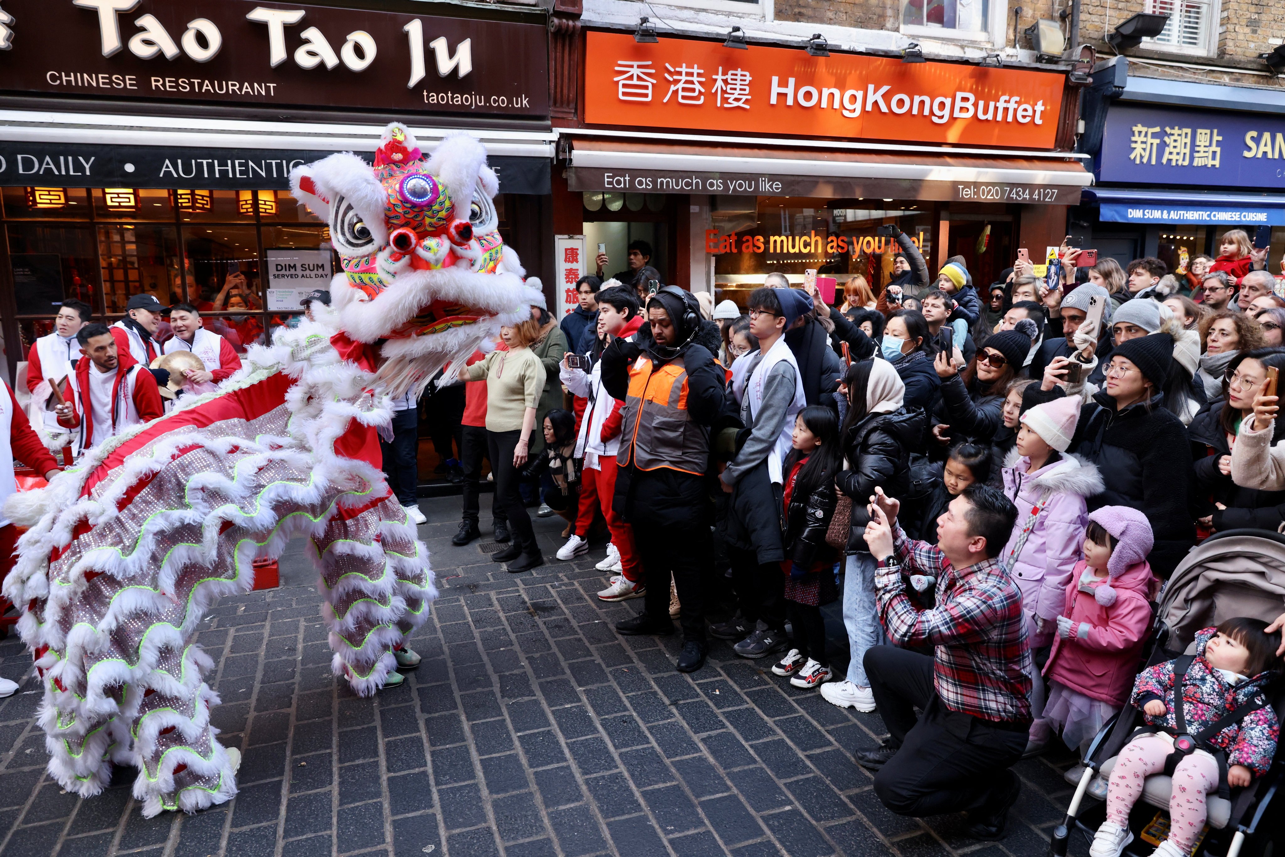 A Chinese lion dance is performed in the streets of Chinatown for the Lunar New Year in London, Britain, on January 21, 2023. While London marks the occasion with festive pop-ups, that’s not the case in most other parts of the UK. Photo: Reuters