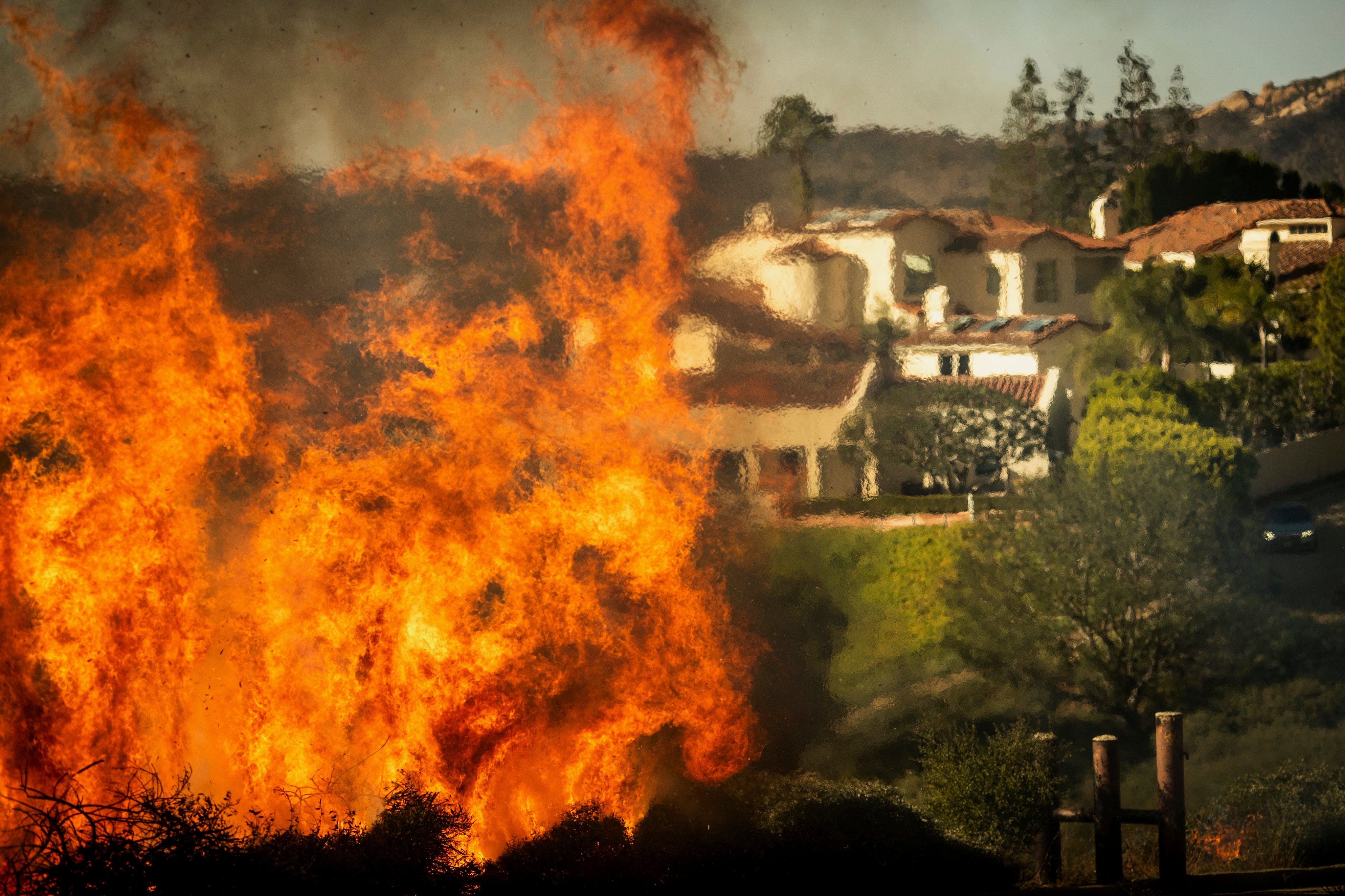 Flames rise as a fire advances on homes in the Pacific Palisades neighbourhood of Los Angeles. Photo: AP