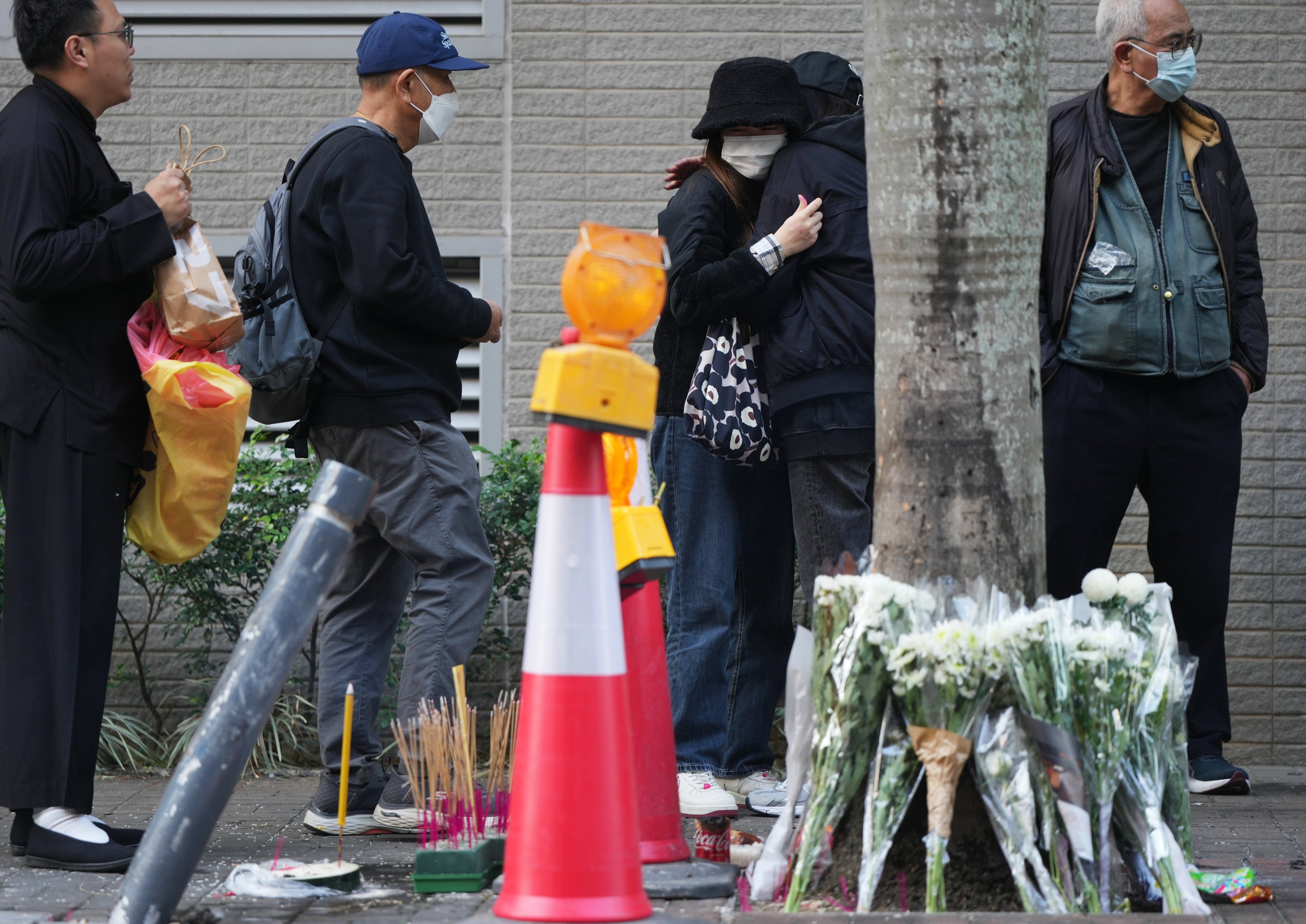 Family members and friends attended a roadside memorial for the deceased motorcyclist in Kowloon Bay on January 8, 2024. Photo: Sam Tsang