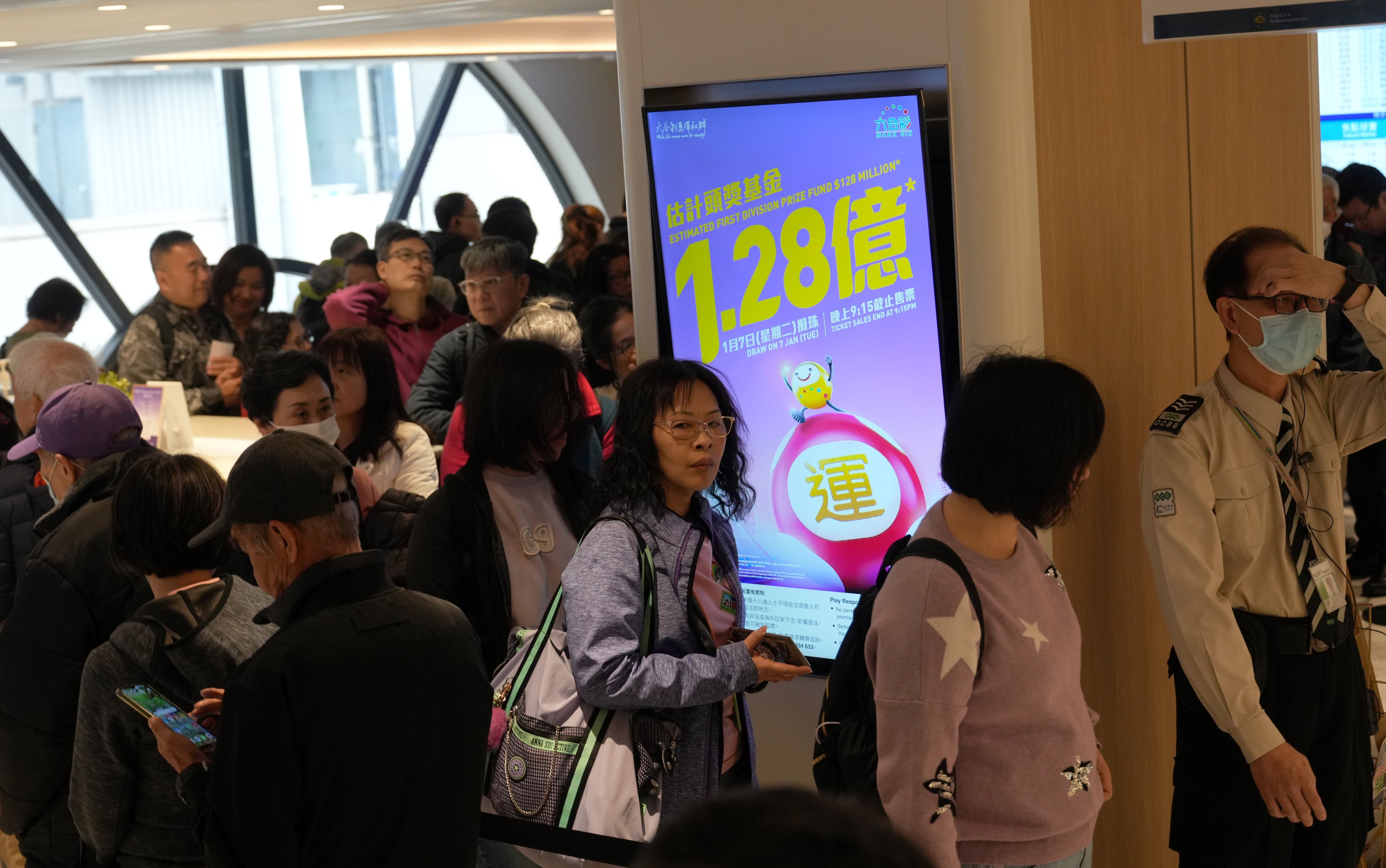 People queue up for Mark Six lottery tickets at a betting branch on Stanley Street in Central. Photo: Sam Tsang