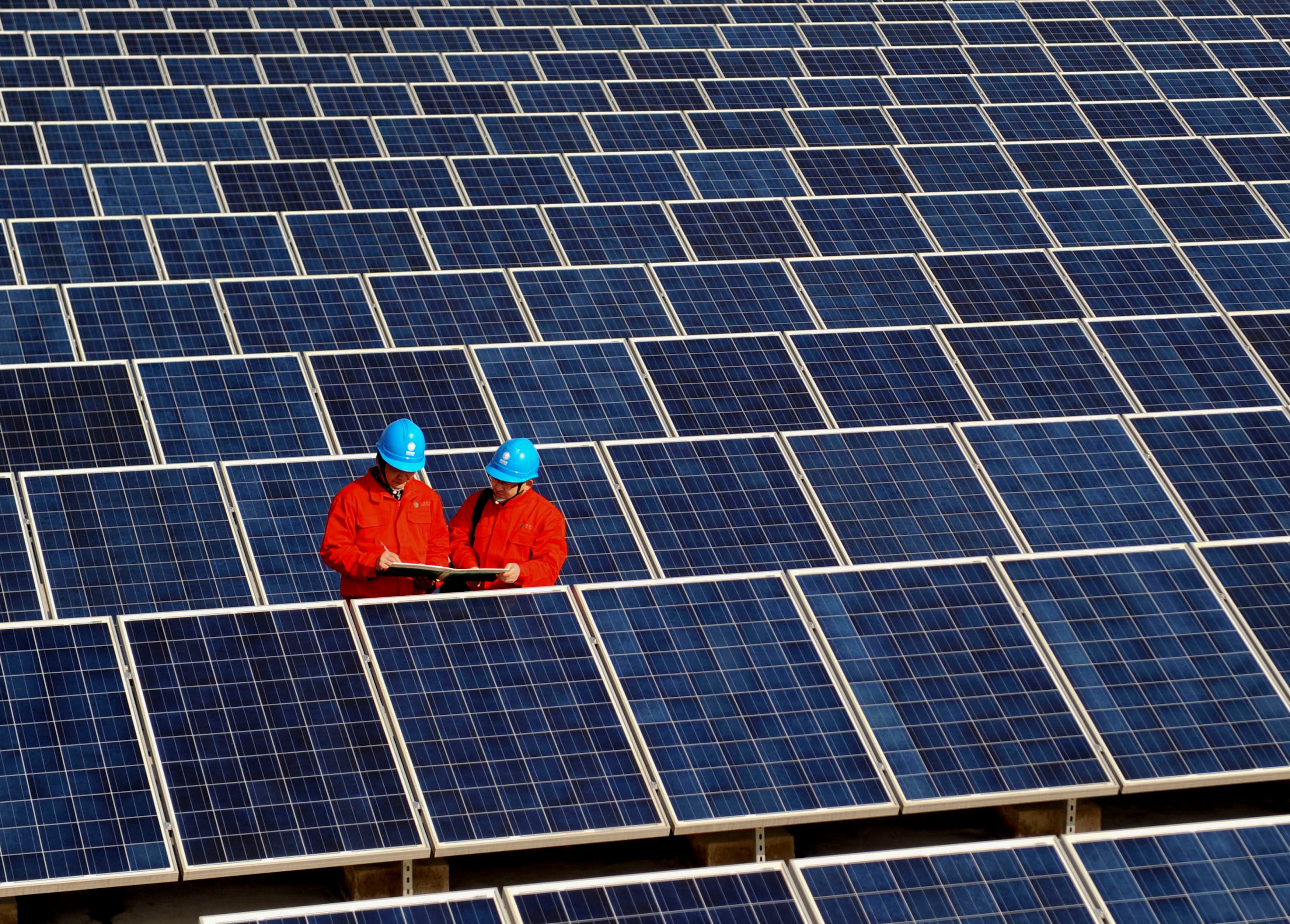 Workers check solar panels at a solar power station on a factory roof in Changxing, eastern China’s Zhejiang province in 2012. Like many other sectors in China, the solar industry has become a global powerhouse but faces headwinds from punitive tariffs abroad to a brutal price war at home. Photo: AP