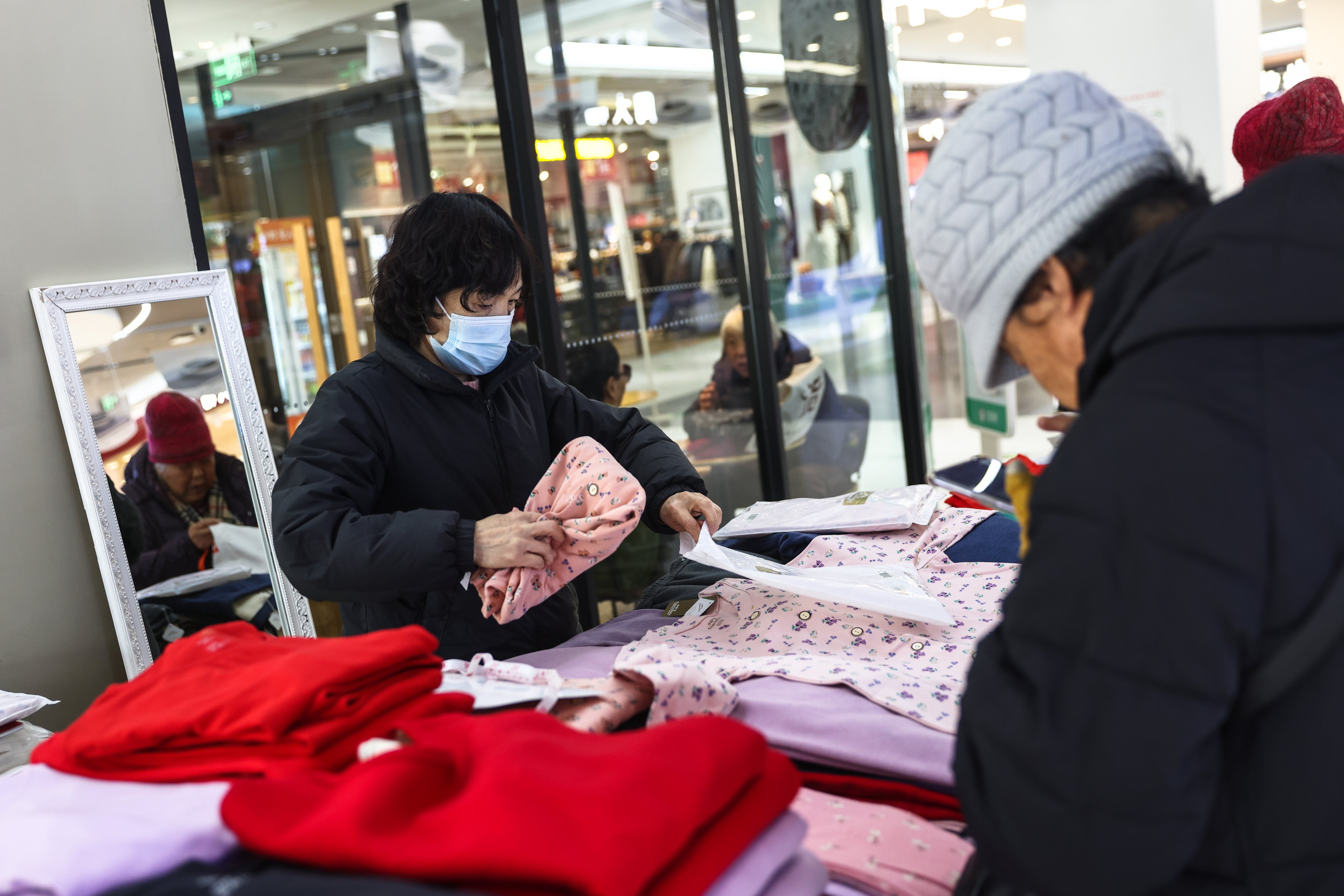 Women shop at a clothing store in Beijing last month. Photo: EPA-EFE