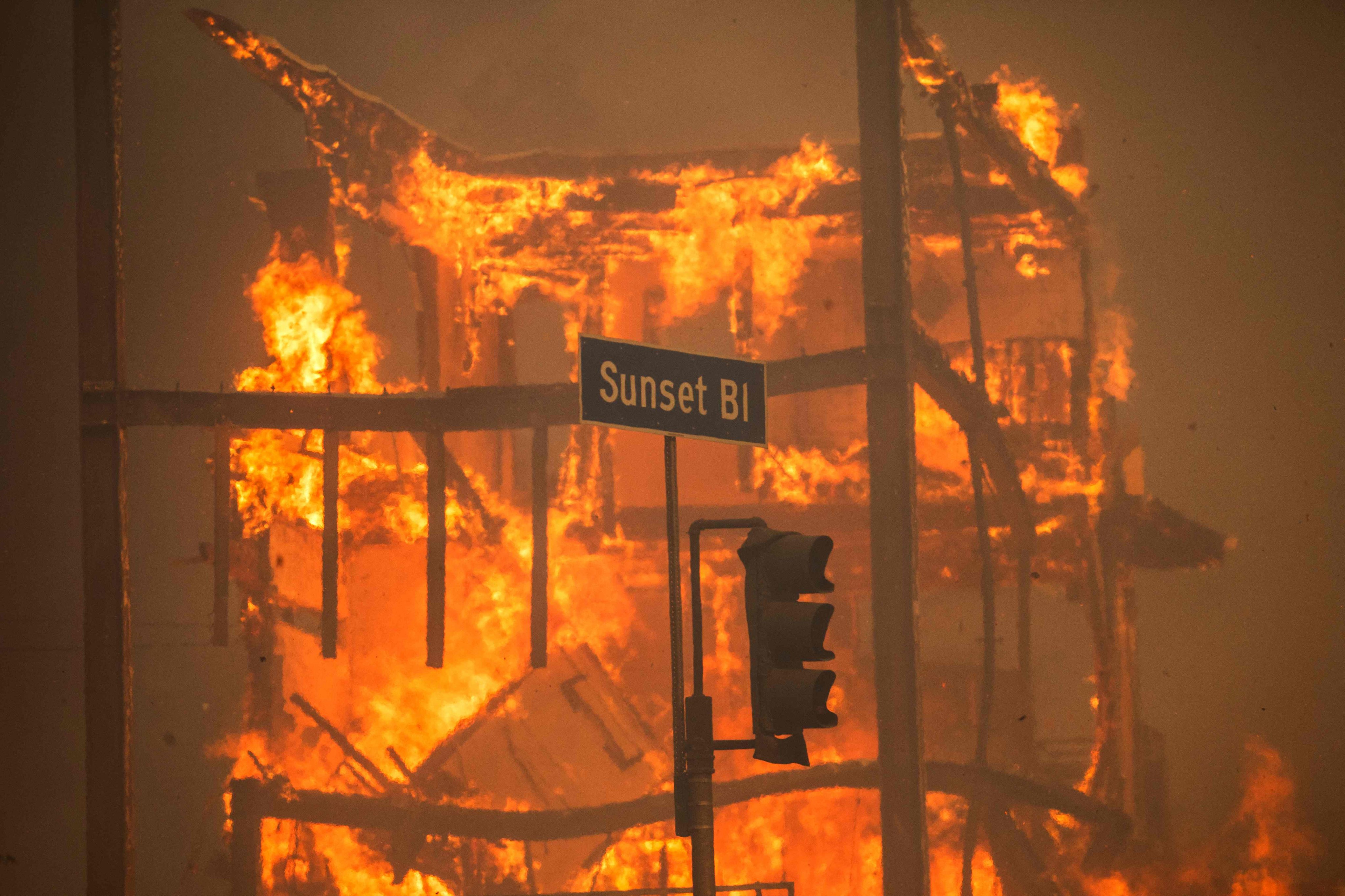 Flames from the Palisades Fire burn a building on Sunset Boulevard. Photo: AFP