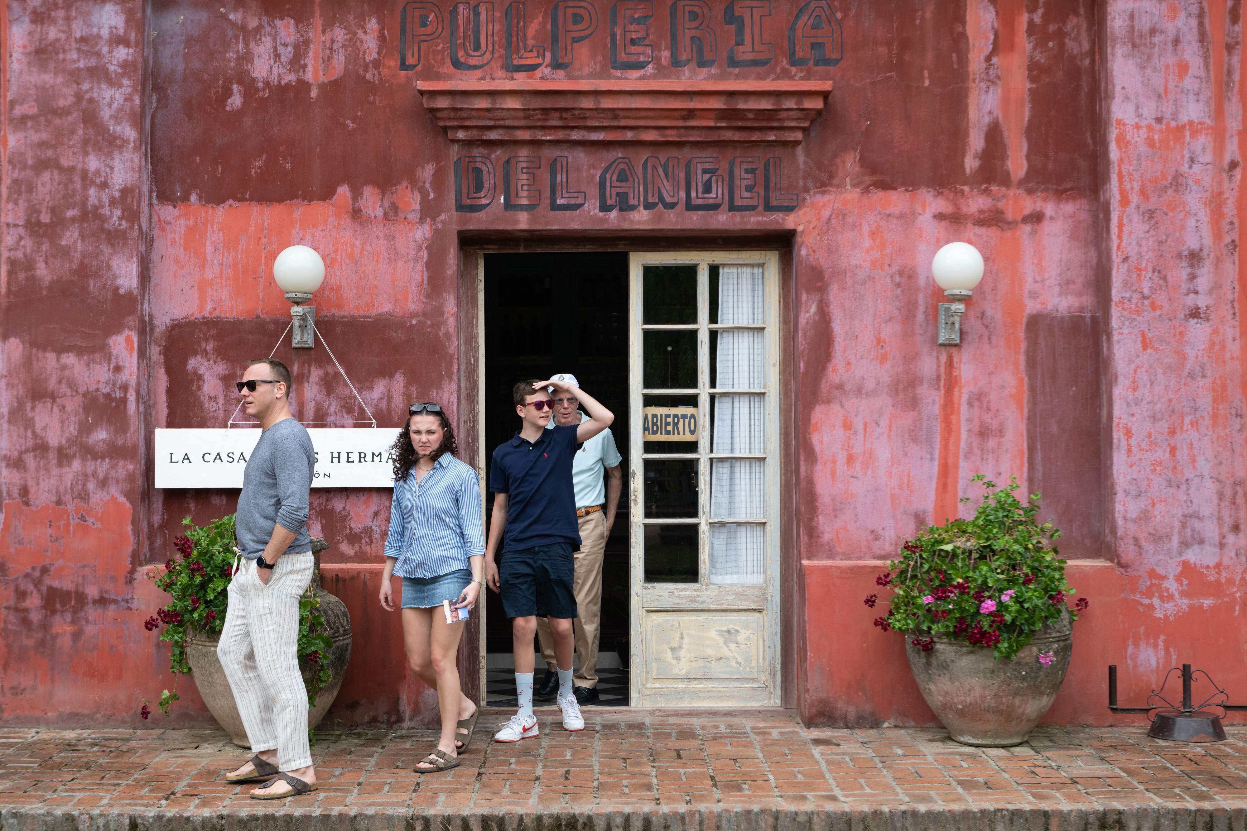 Tourists in front of a store in Pueblo Garzon, Uruguay, during preparations for its Campo Artfest in December 2024. Photo: AFP