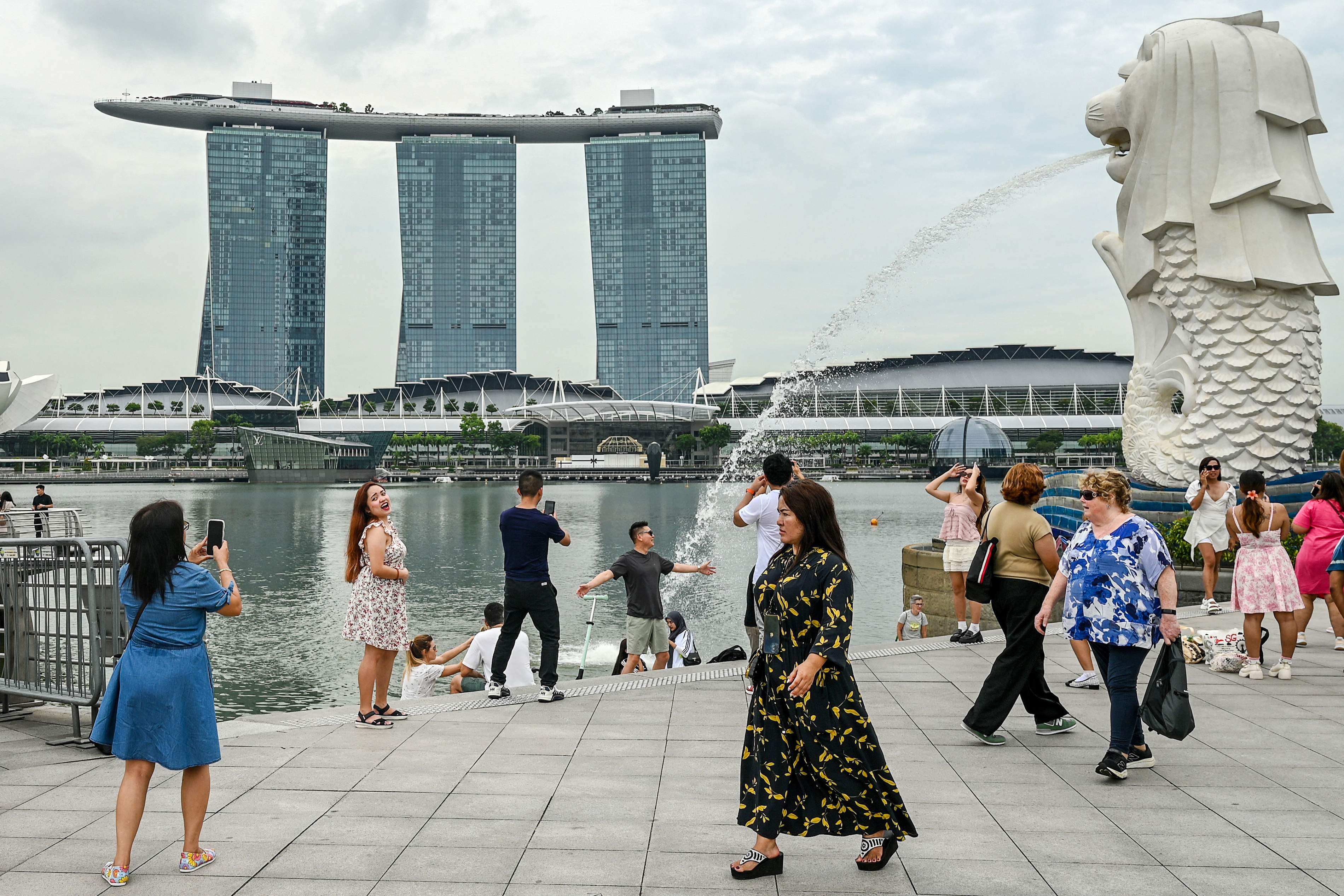 People gather in front of the Marina Bay Sands resort in Singapore. Photo: AFP