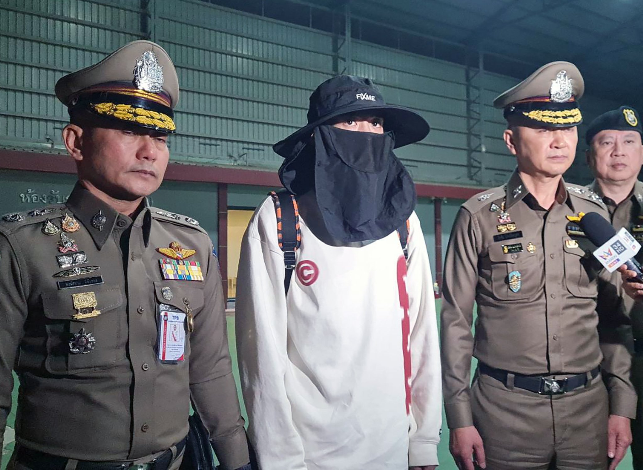 A handout photo from the Royal Thai Police shows Chinese actor Wang Xing being escorted by officers after returning from Myanmar, at the police airport in Bangkok, Thailand, on Tuesday. Photo: EPA-EFE