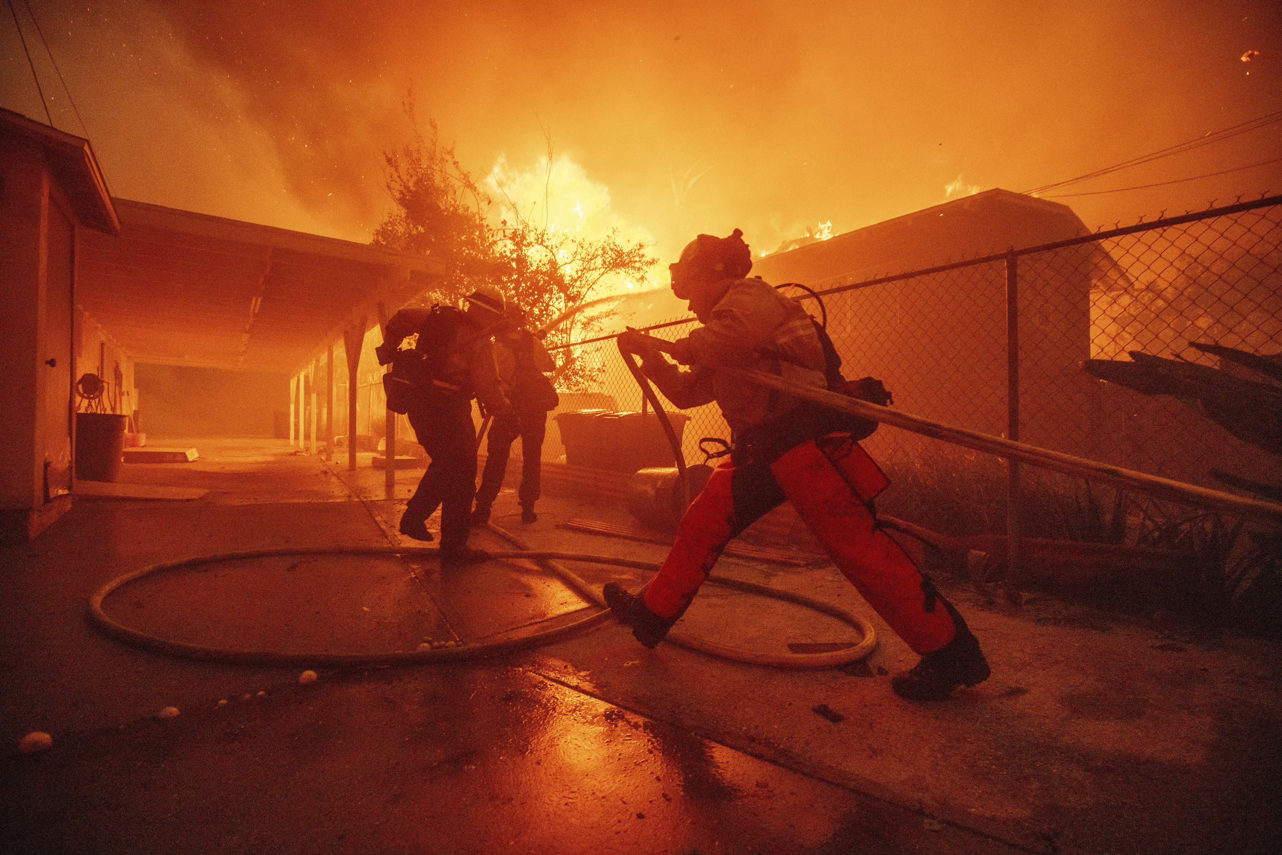 Firefighters protect a structure as the Eaton Fire advances in Altadena, California, on Wednesday. Photo: AP