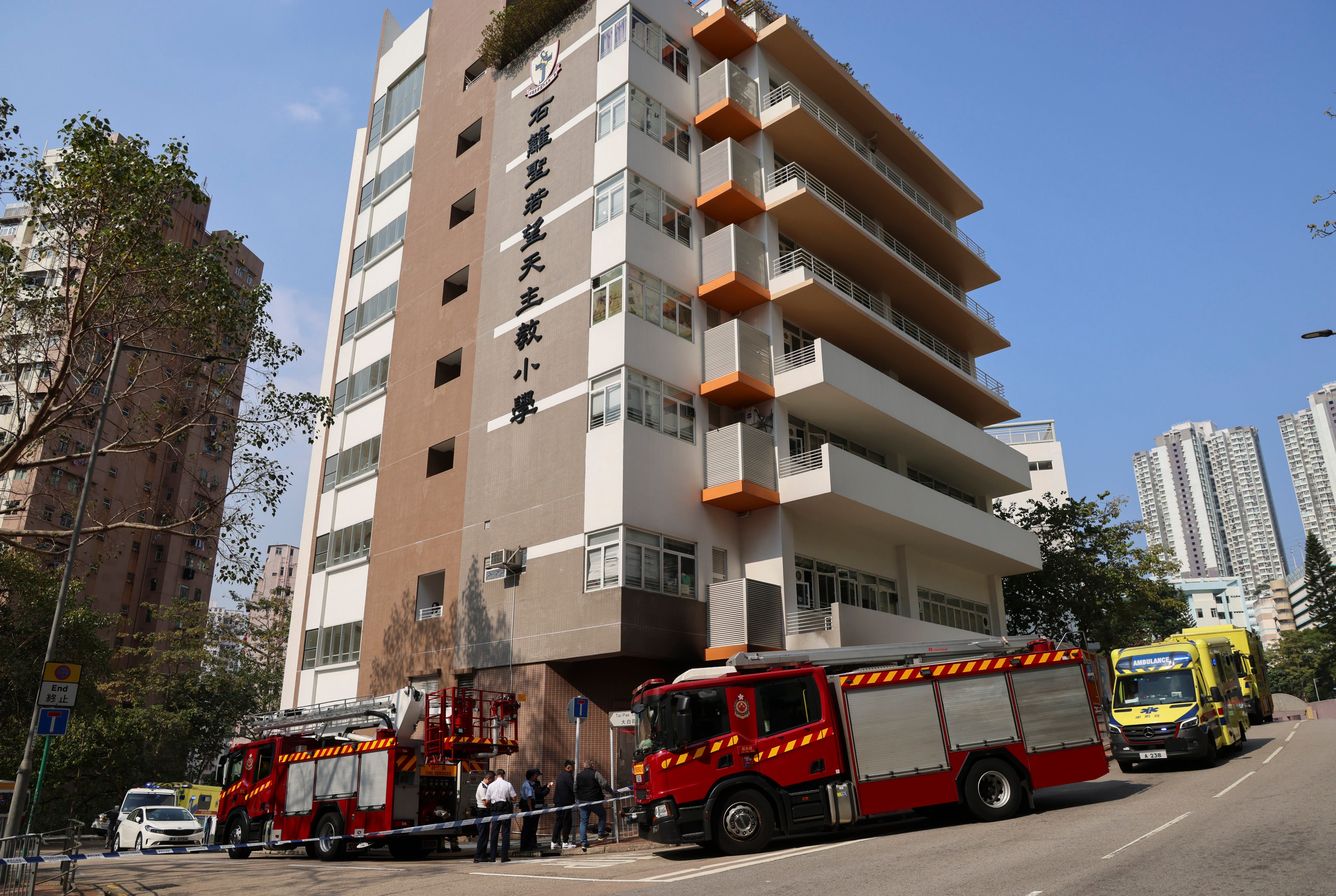 Firefighters investigate a trolley set alight in a suspected arson case outside Shek Lei St. John’s Catholic Primary School in Kwai Chung. Photo: Jelly Tse