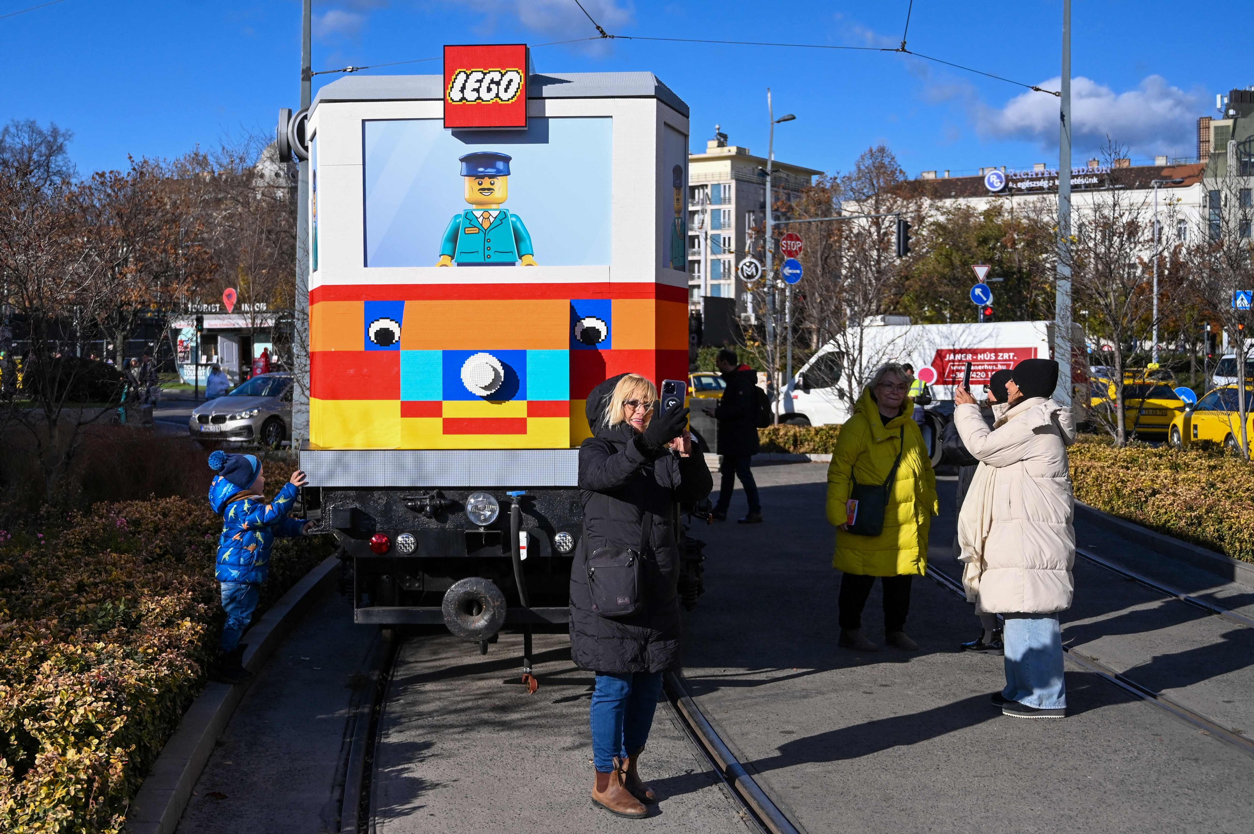 Visitors take photos in front of a full-size tram built from Lego bricks in downtown Budapest. Photo: AFP