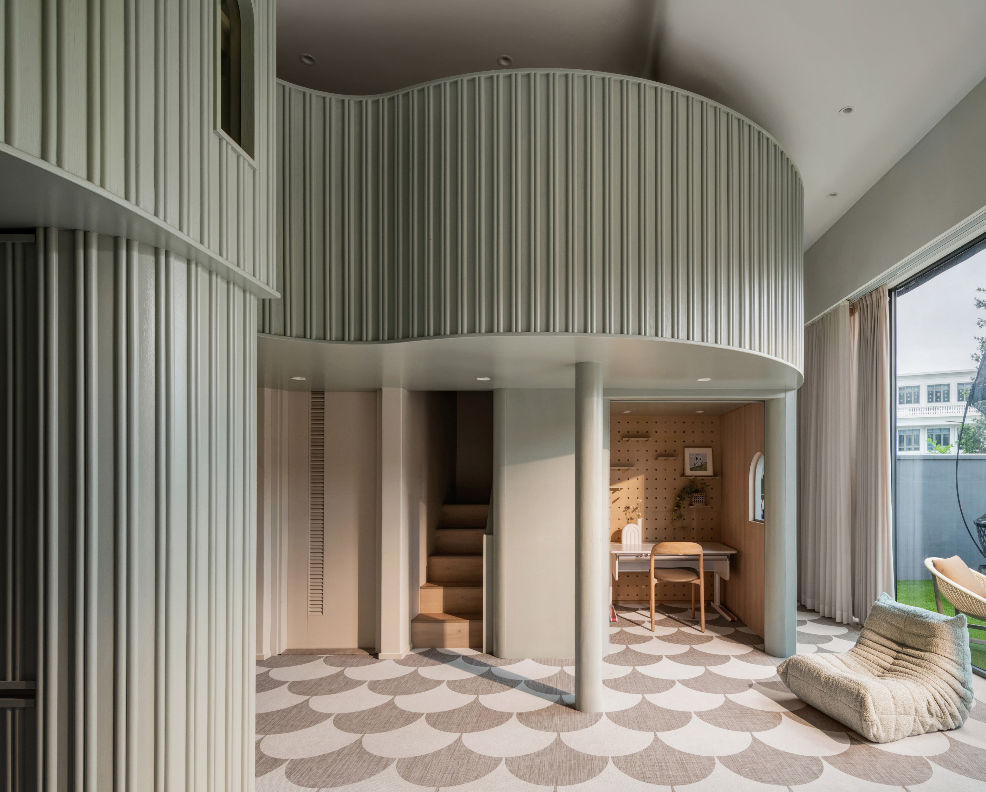 This triplex in Tuen Mun, Hong Kong, has a cavernous lower ground floor with a double-height ceiling. Photo: Steven Ko Photography