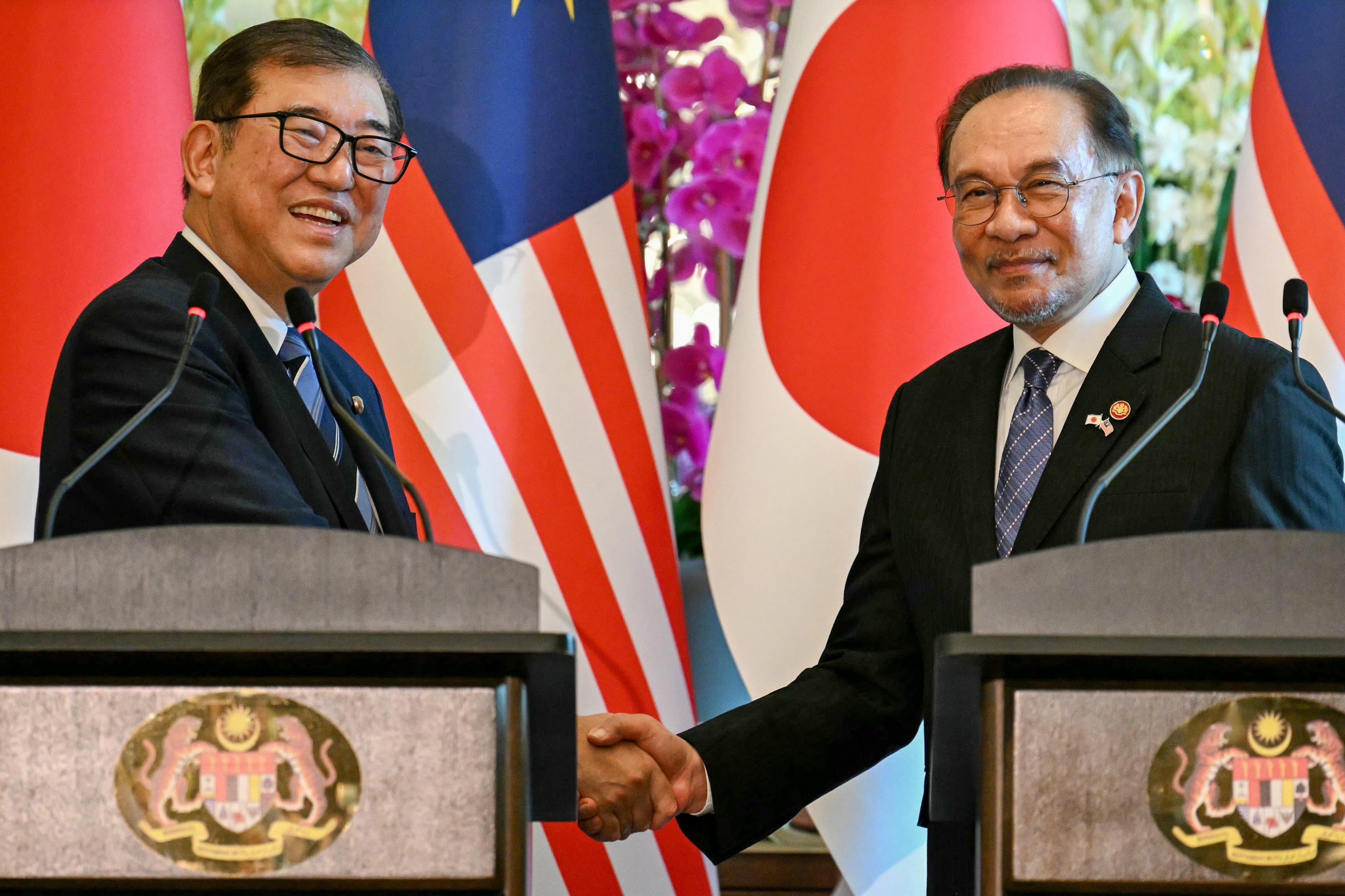 Malaysia’s Prime Minister Anwar Ibrahim and Japan’s Prime Minister Shigeru Ishiba shake hands at a press conference in Putrajaya on Friday. Photo: EPA-EFE