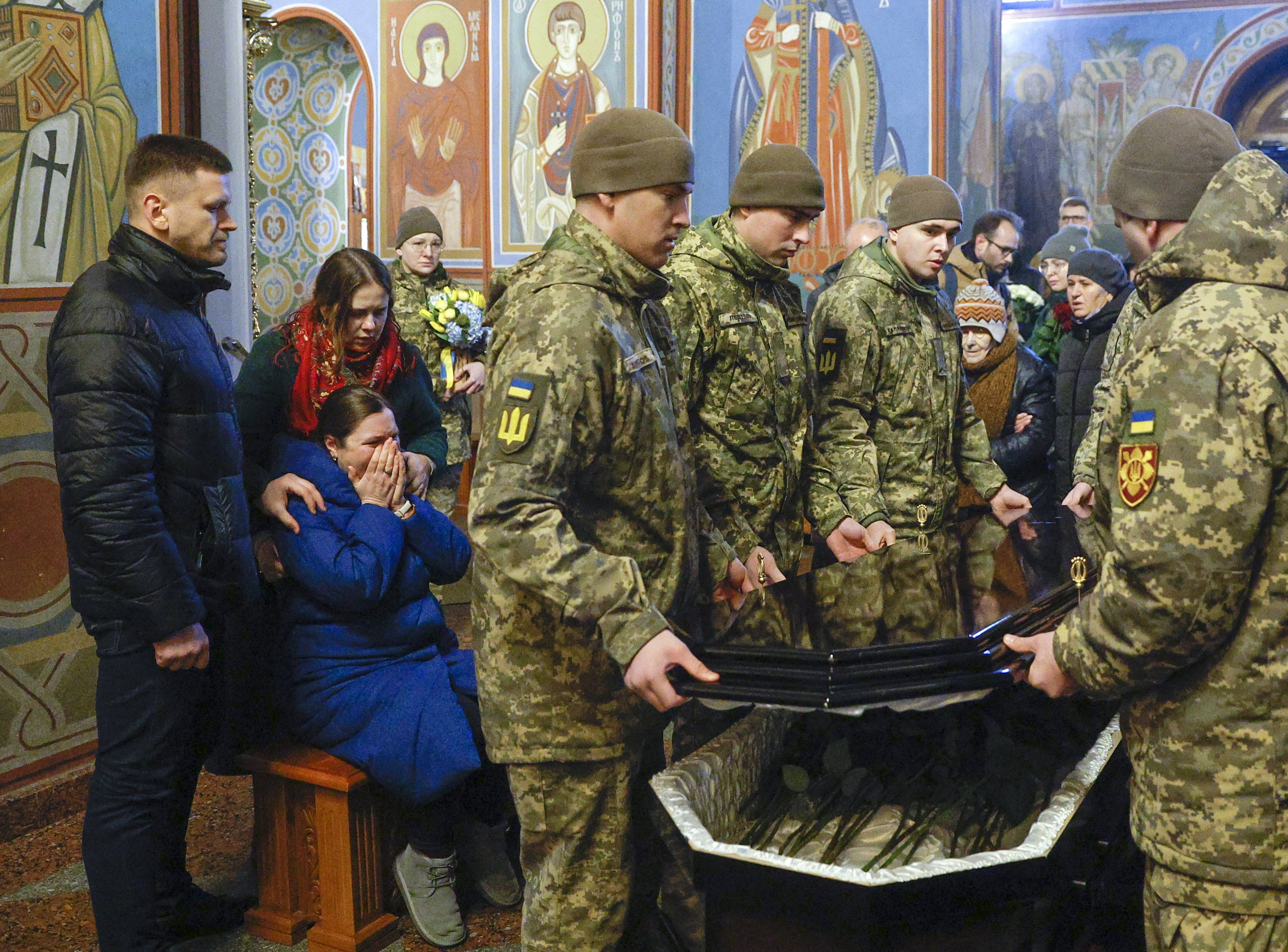 Relatives, friends, and colleagues of Ukrainian marine Andriy Kuzmenko attend his funeral in Kyiv on Friday. Russian troops invaded Ukraine in February 2022. Photo: EPA-EFE