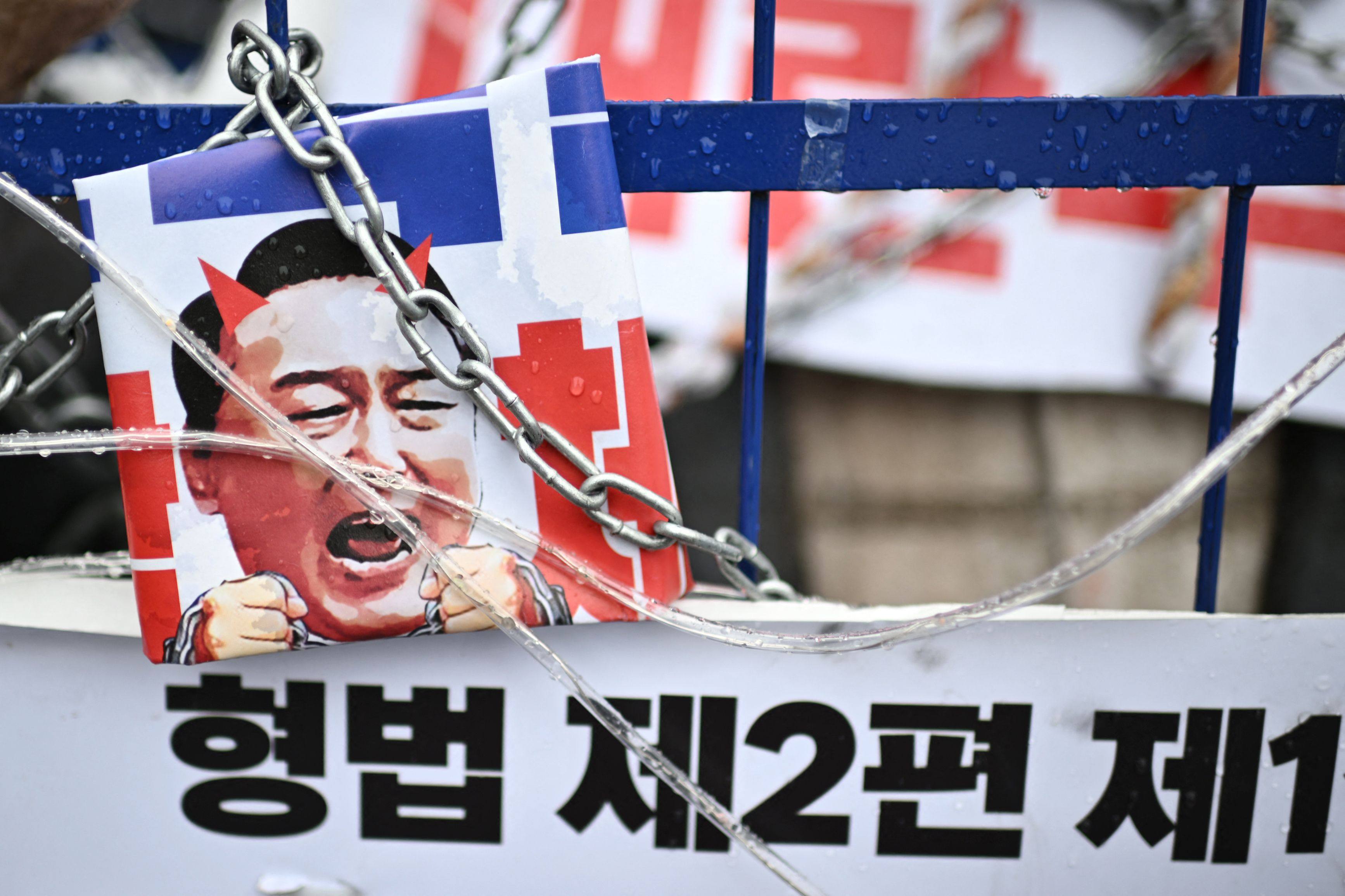 A placard of impeached South Korea President Yoon Suk-yeol with horns is seen on an installation during a rally against Yoon near his residence in Seoul on January 5, 2025. Photo: AFP