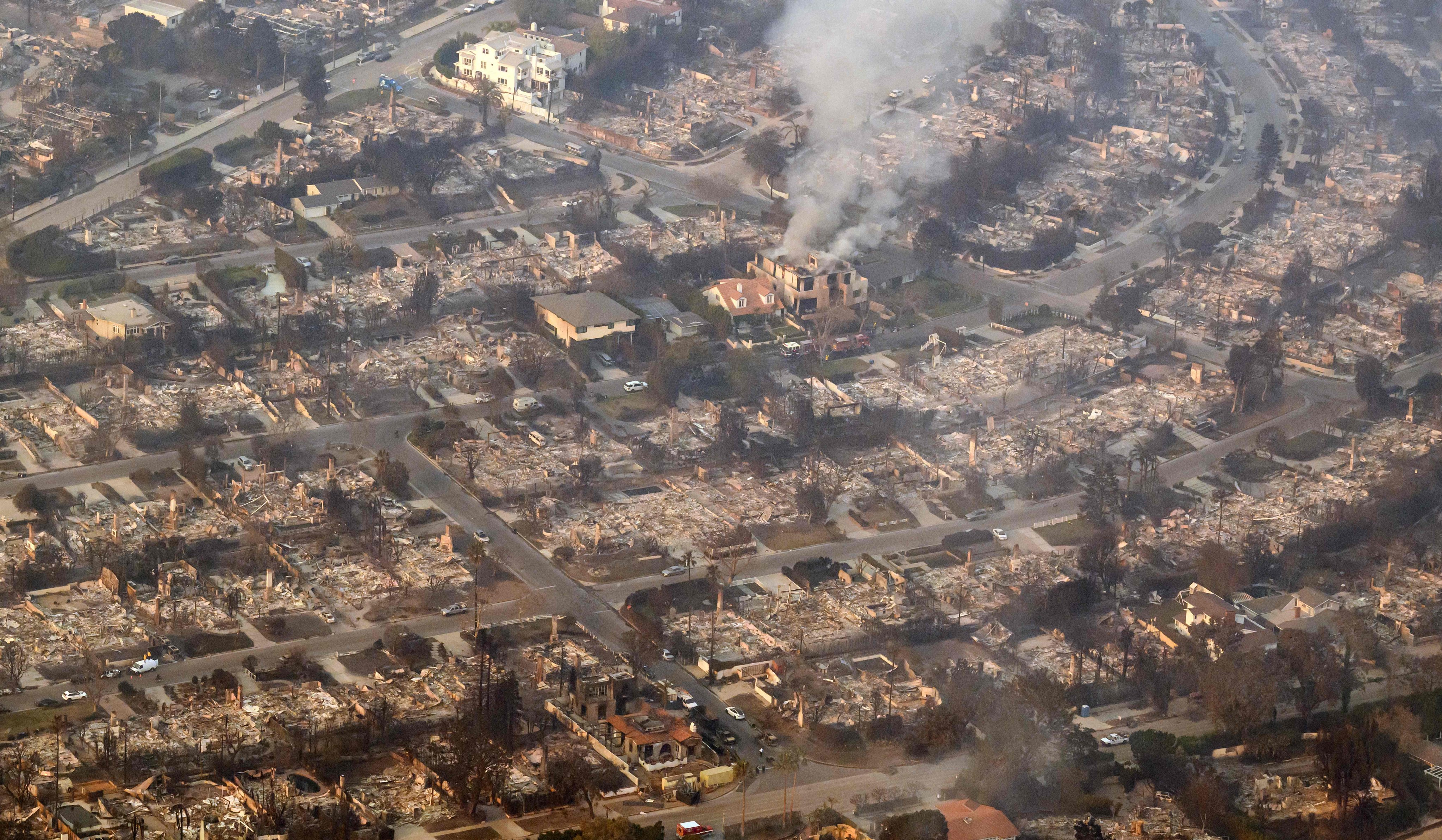 Homes burned from the Palisade Fire smoulder near the Pacific Palisades neighbourhood of Los Angeles. Photo: AFP