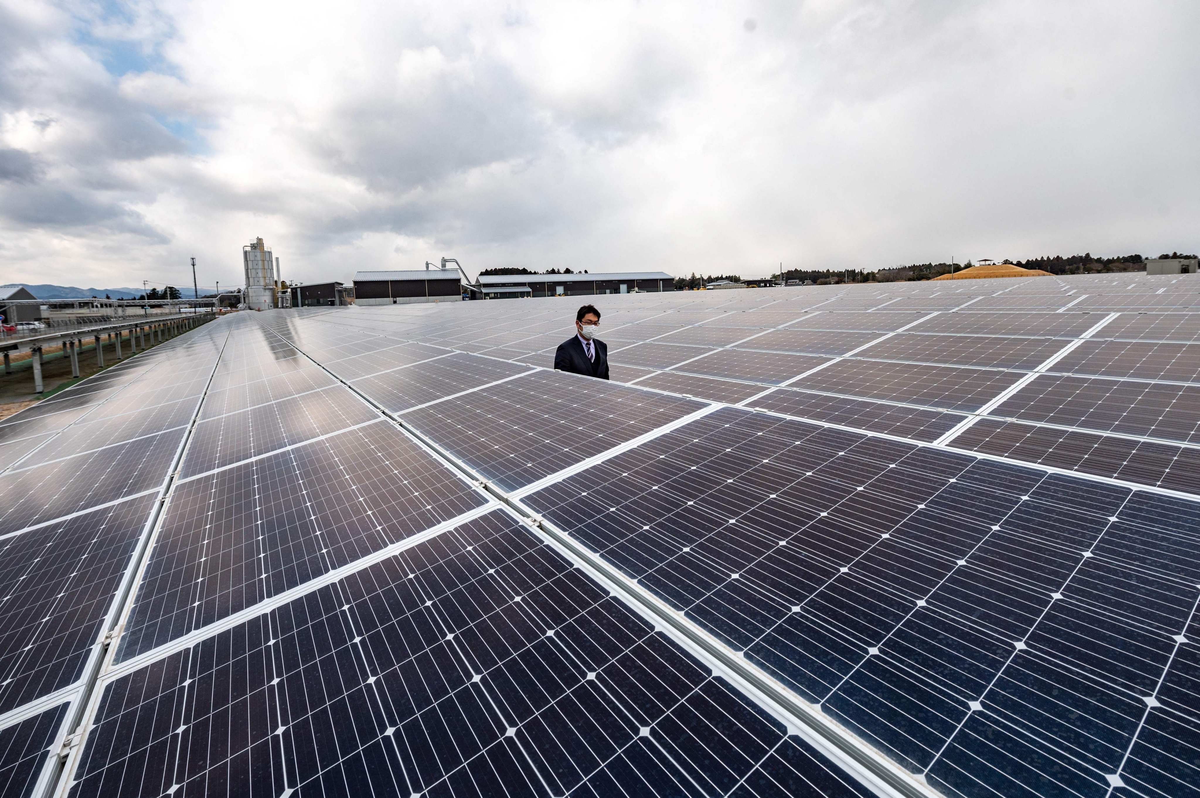 A man walks through solar power generation facilities in Fukushima prefecture. Thieves have regularly targeted solar farms in Japan, making off with copper transmission wire, aluminium supports for solar panels and even lengths of metal fencing and posts. Photo: AFP