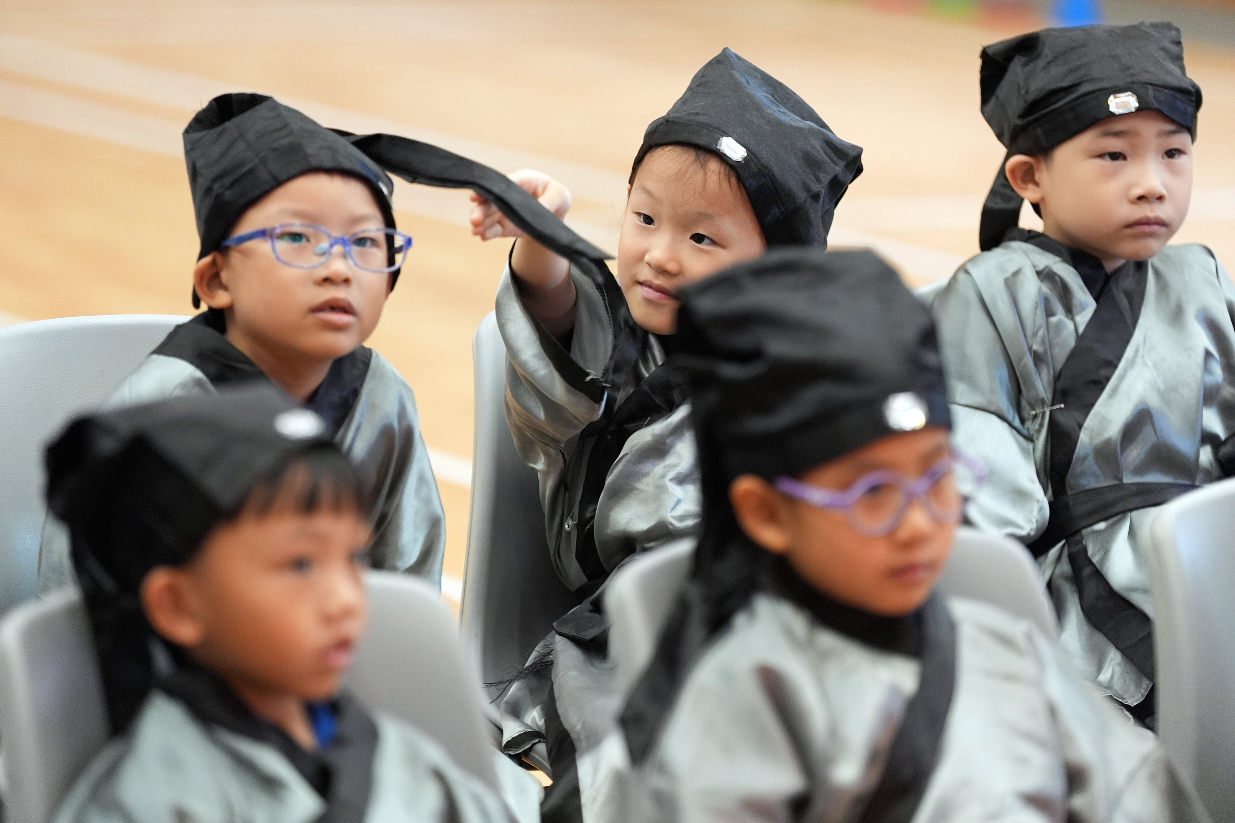 Confucian Tai Shing Primary School pupils in Wong Tai Sin wear Confucian robes at a ceremony for new students on September 2. Photo: Eugene Lee