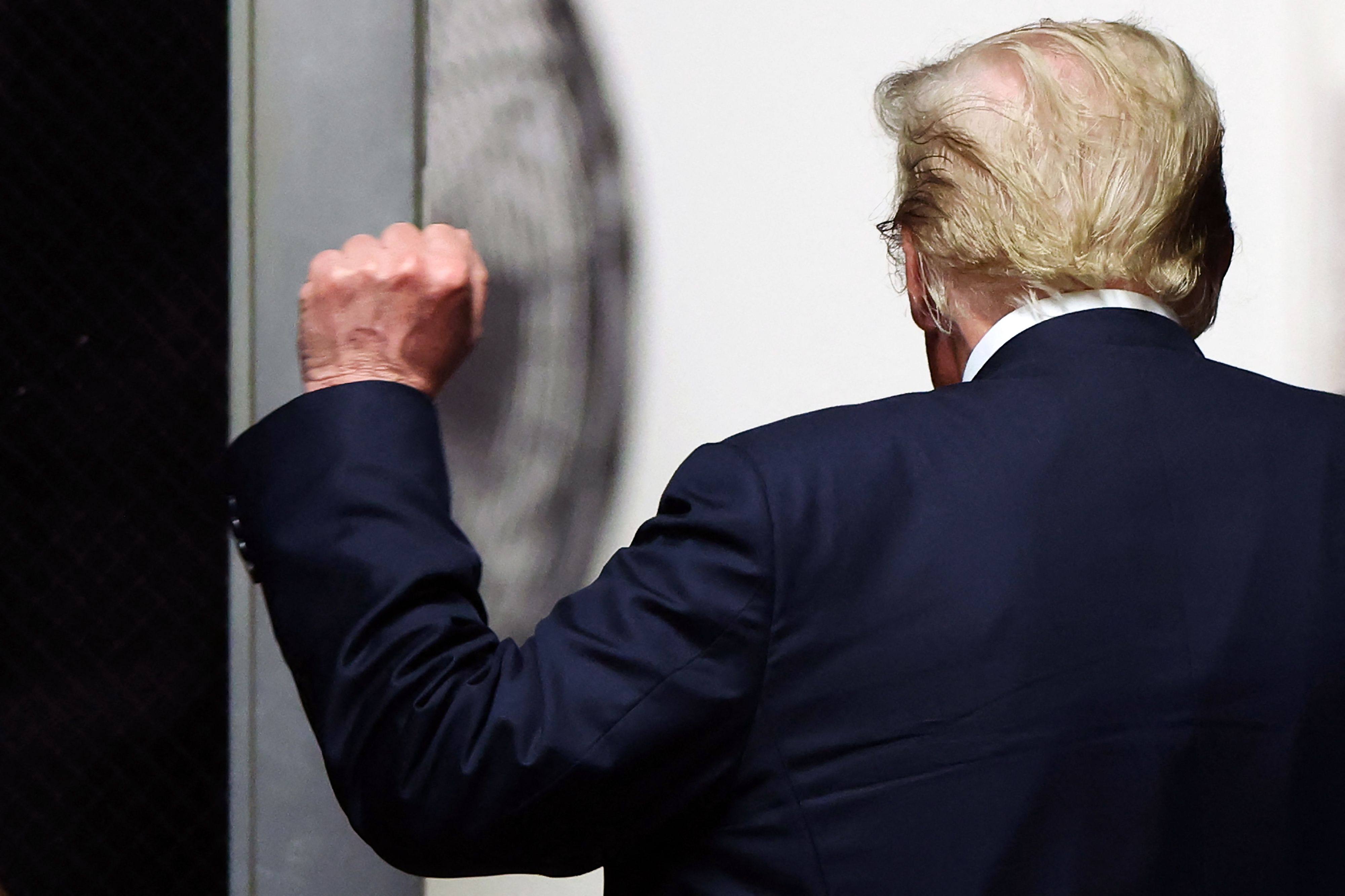 Donald Trump holds up a fist as he walks to the courtroom after the start of deliberations in his criminal trial at Manhattan Criminal Court in New York City, on May 29, 2024. Photo: AFP/Pool