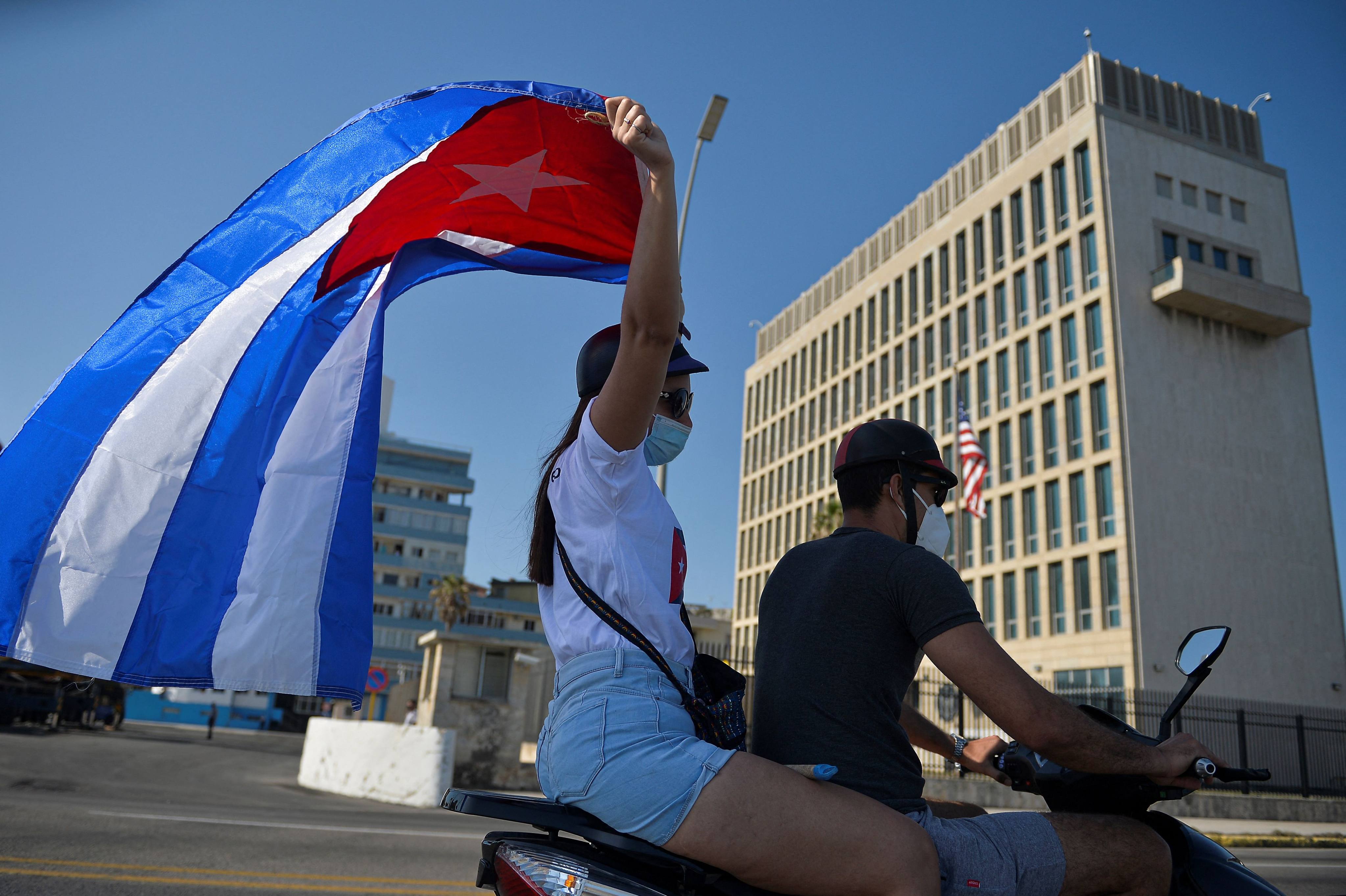 Cubans drive past the US embassy in Havana in March 2021. US embassy personnel in the city were the first to raise concerns, which later led the series of health effects to be dubbed “Havana Syndrome”. Photo: AFP