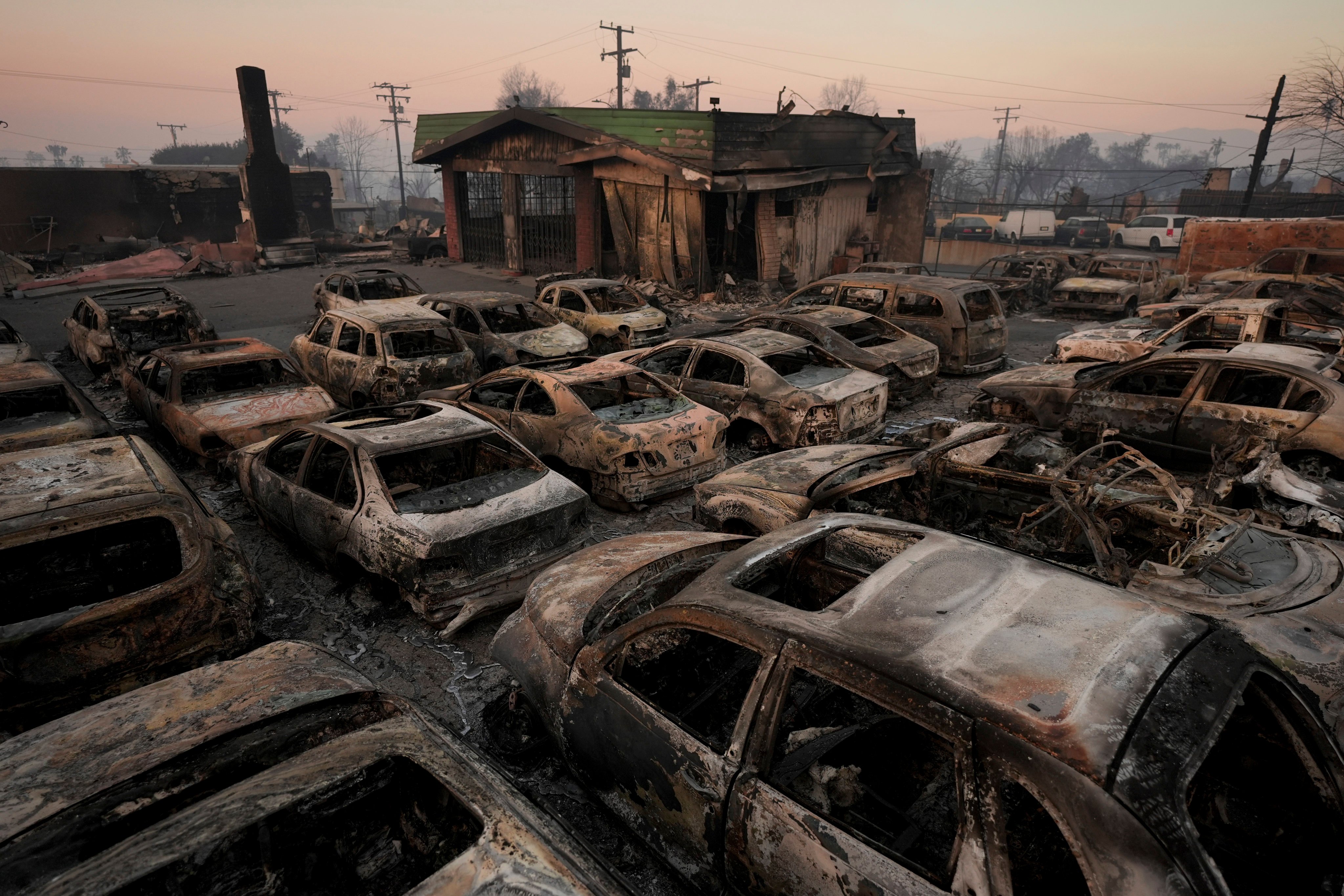 Cars are left charred inside a dealership in the aftermath of the Eaton fire in Altadena, California, on Friday. Photo: AP