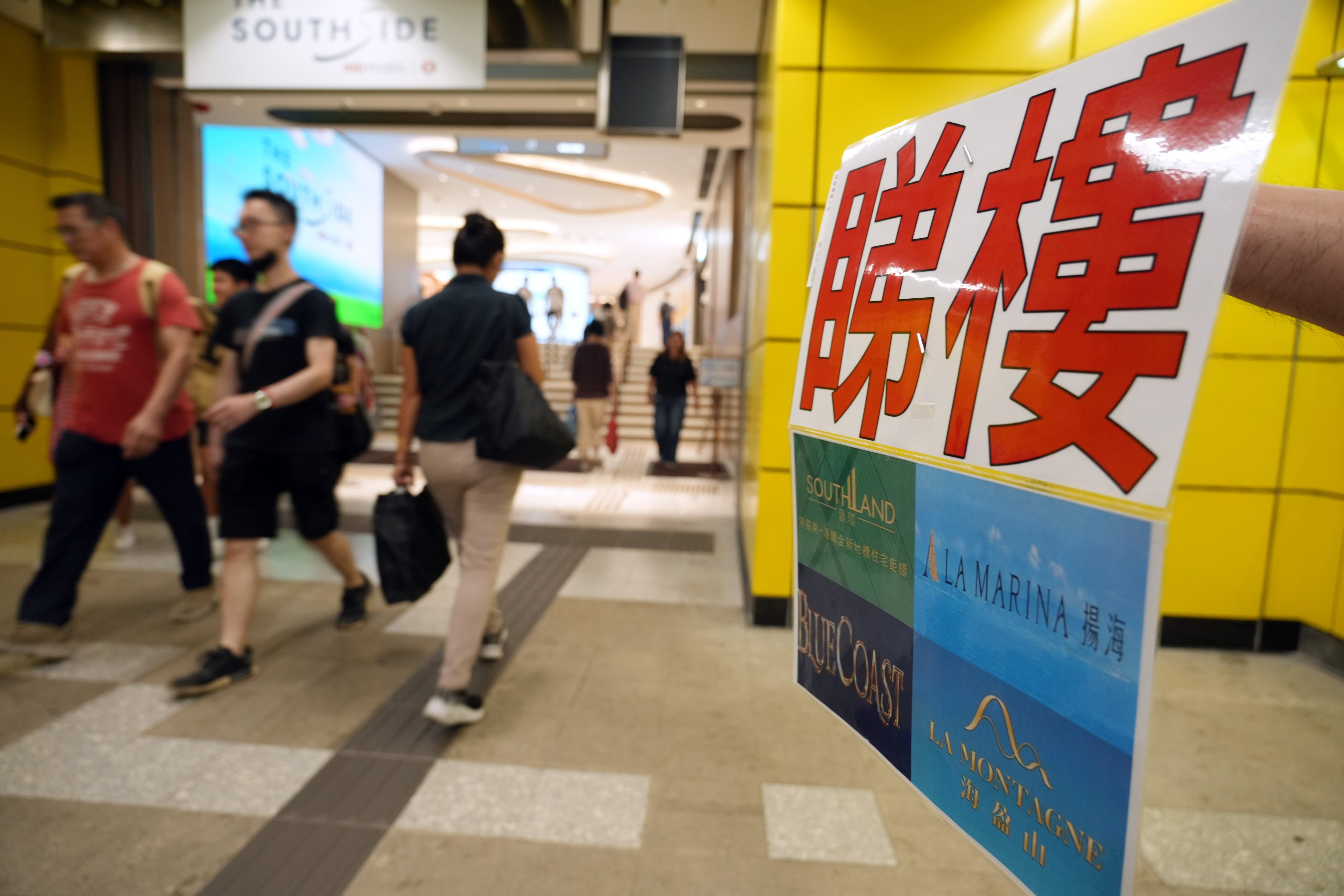 A property agent soliciting business at Wong Chuk Hang MTR Station. Photo: Sam Tsang