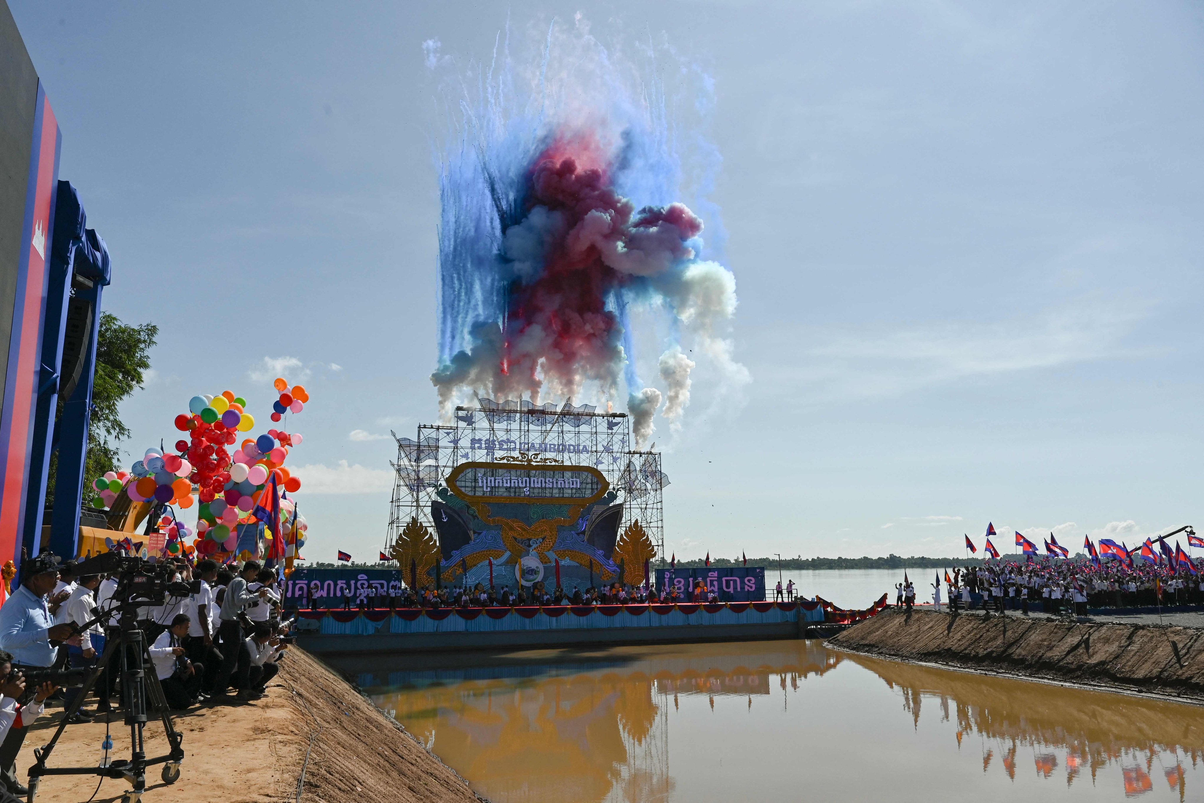 Colourful smoke bombs mark the groundbreaking ceremony for the Funan Techo canal in Cambodia’s Kandal province, in August last year. Photo: AFP