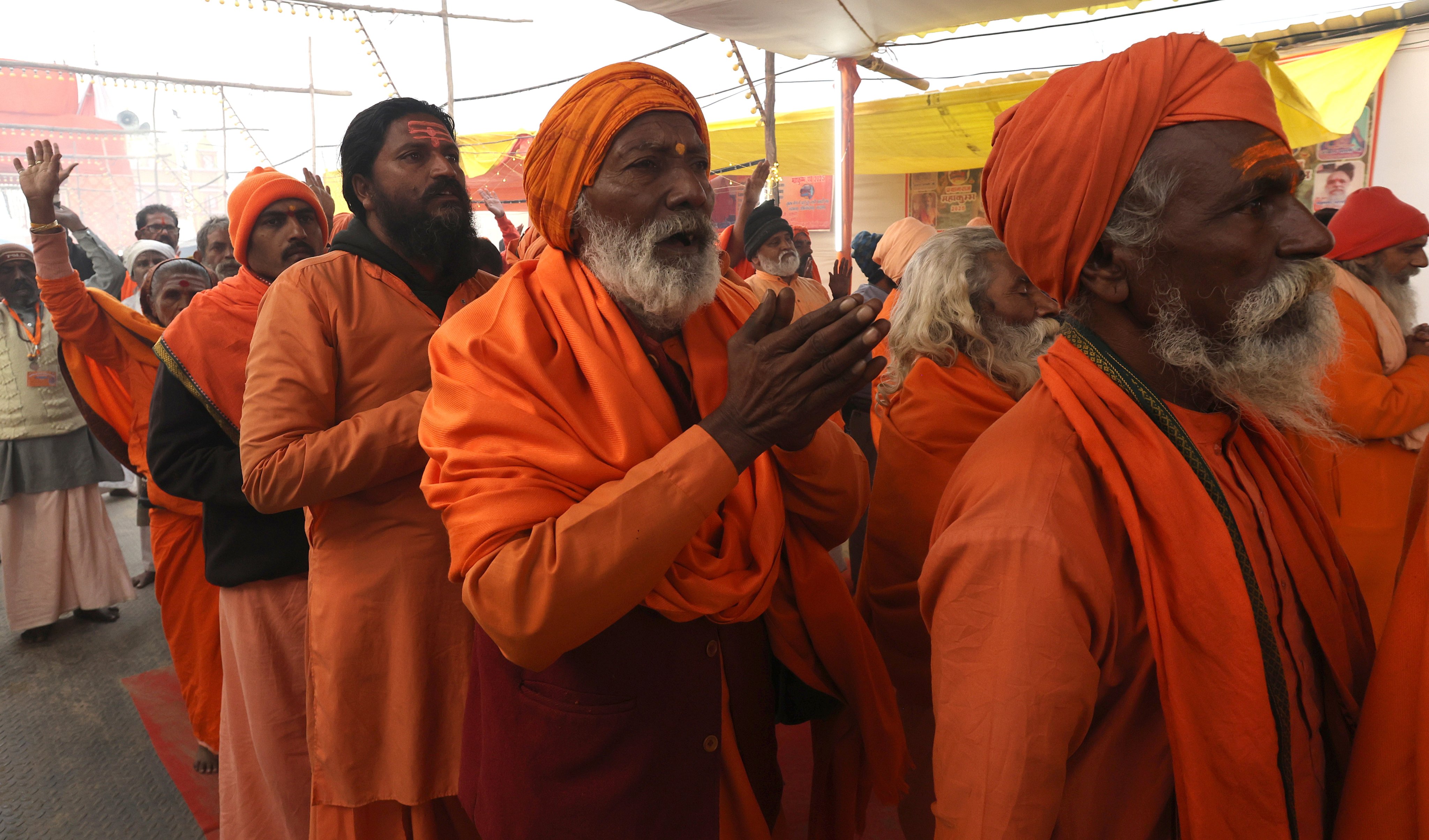 Members of Taponidhi Shri Anand Akhara Panchayati pray ahead of the royal bath near the Sangam, on Sunday. Photo: EPA-EFE